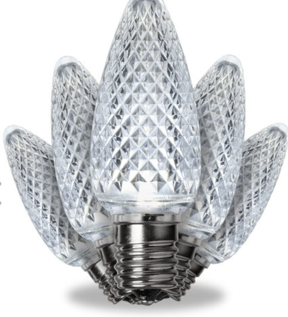Close-up of a multi-faceted, crystal-like LED light bulb with a metal screw base.