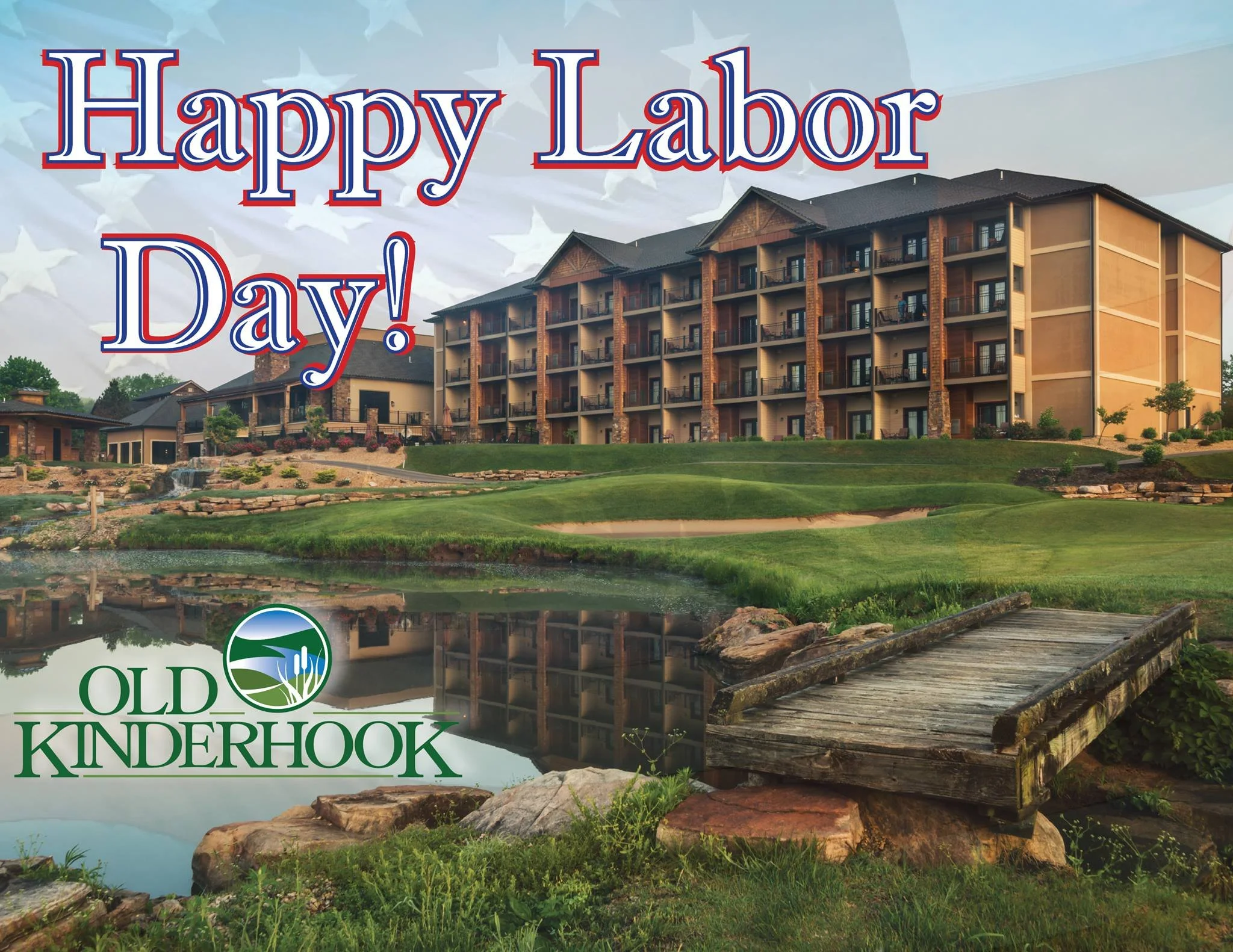 A resort or hotel building by a lake with a wooden dock in the foreground. The image has text that reads 'Happy Labor Day!'