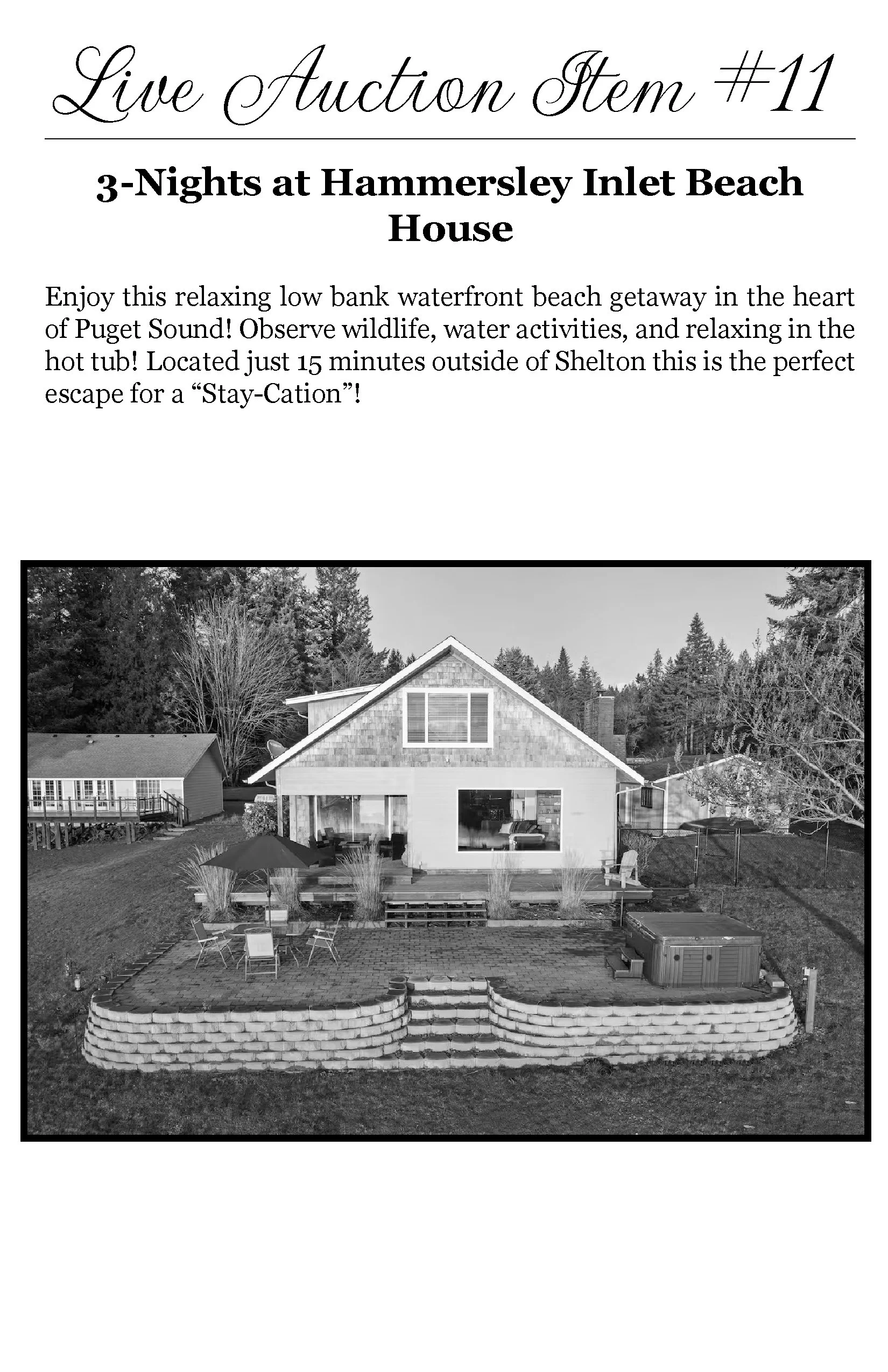 A black and white photo of a house with a backyard patio area, outdoor furniture, umbrellas, a hot tub, and gardening beds, with trees in the background.
