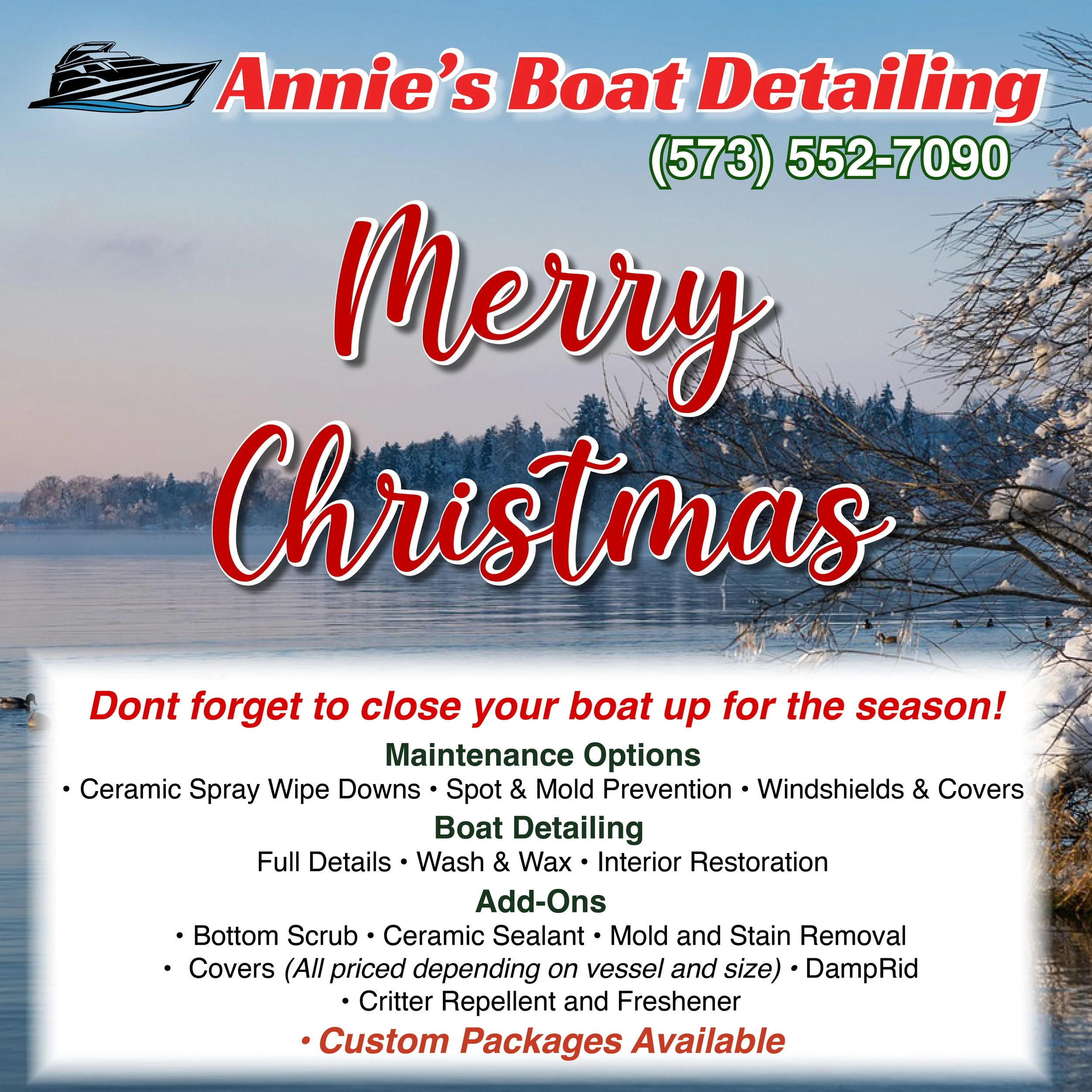 Sign for Annie's Boat Detailing with a winter landscape background of a lake, snow-covered trees, and a cloudy sky. The sign features red and green text, a boat logo, and a promotional message.