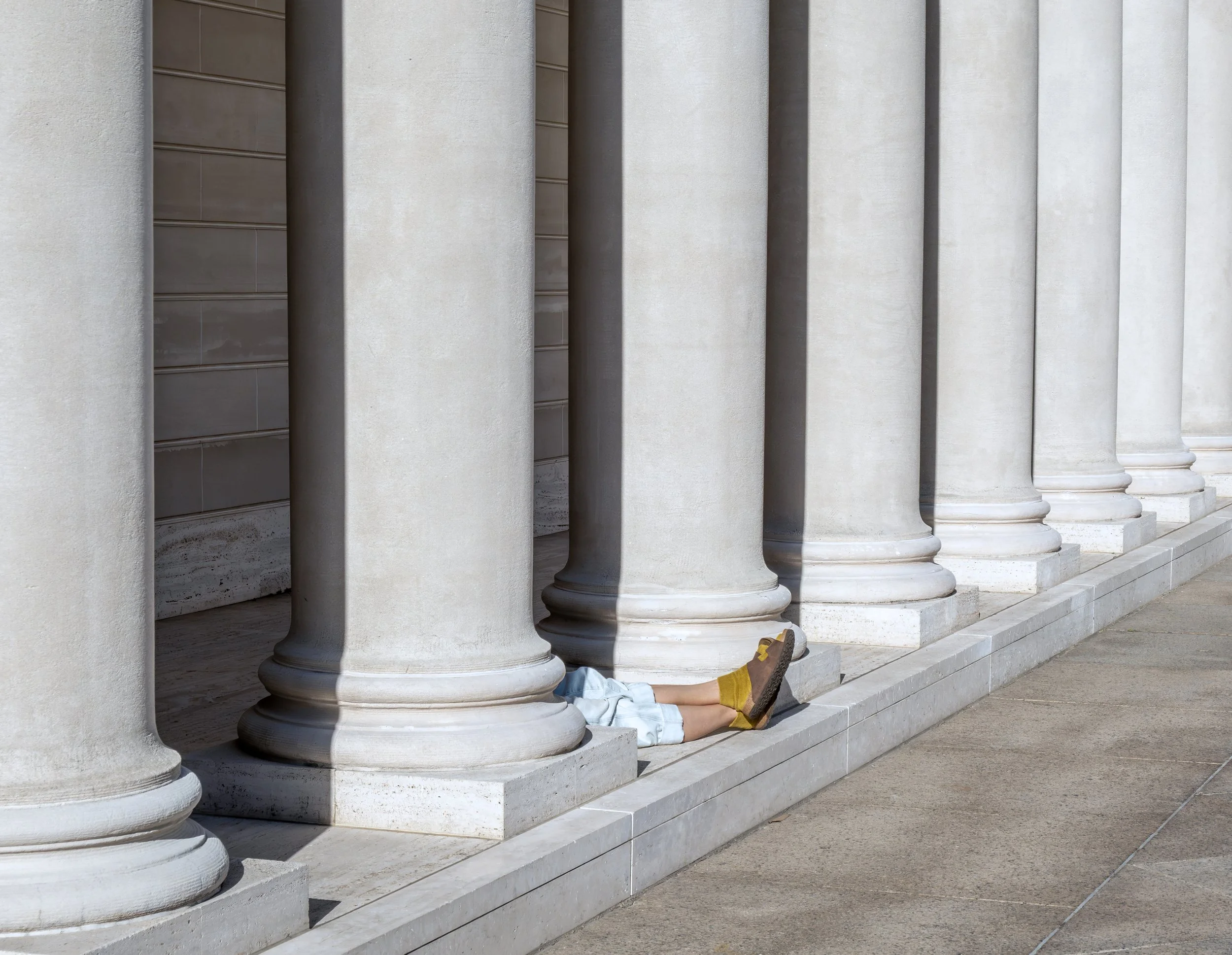 Columns with legs and feet protruding