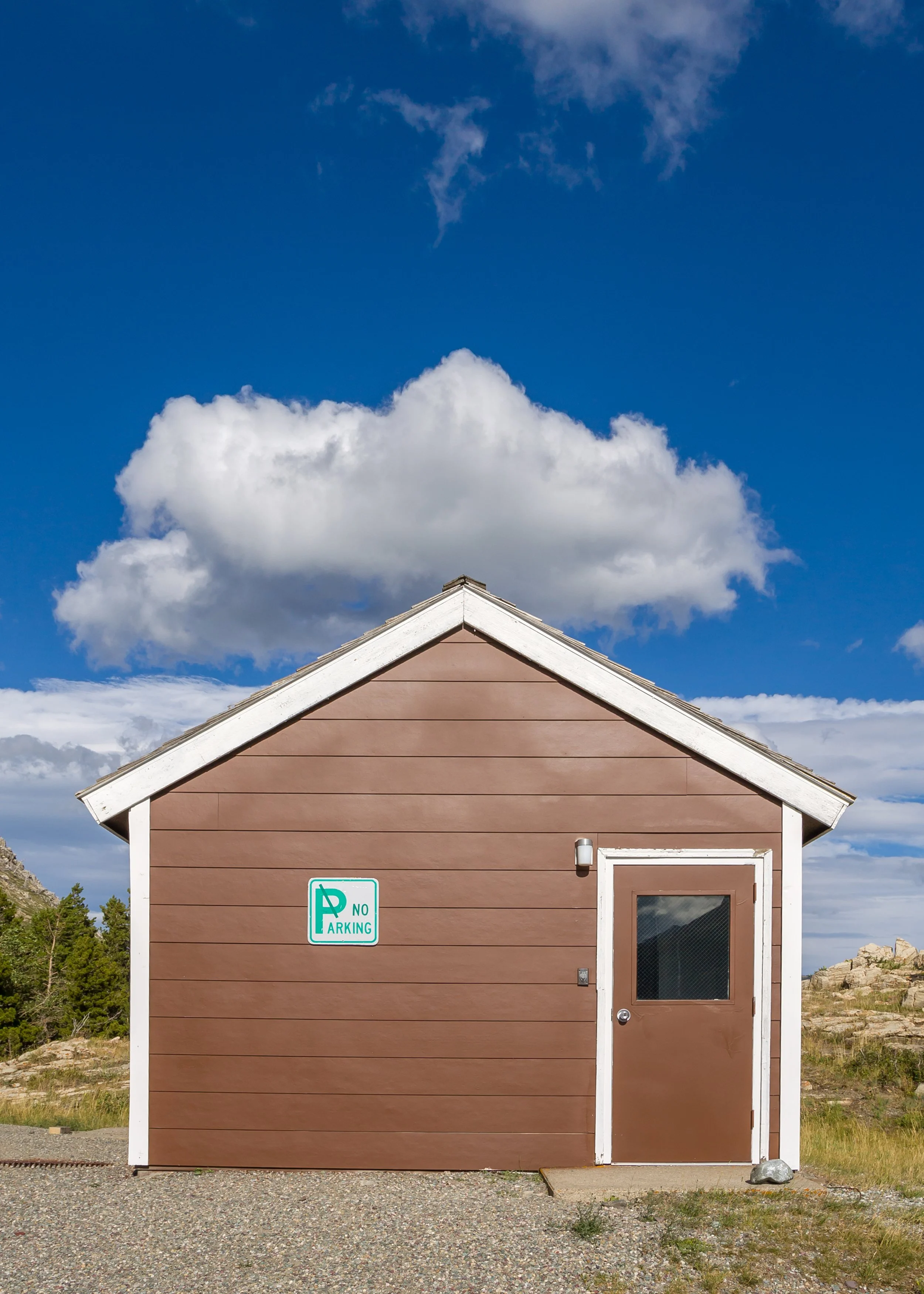 Small buiilding with cloud above, Glacier NP