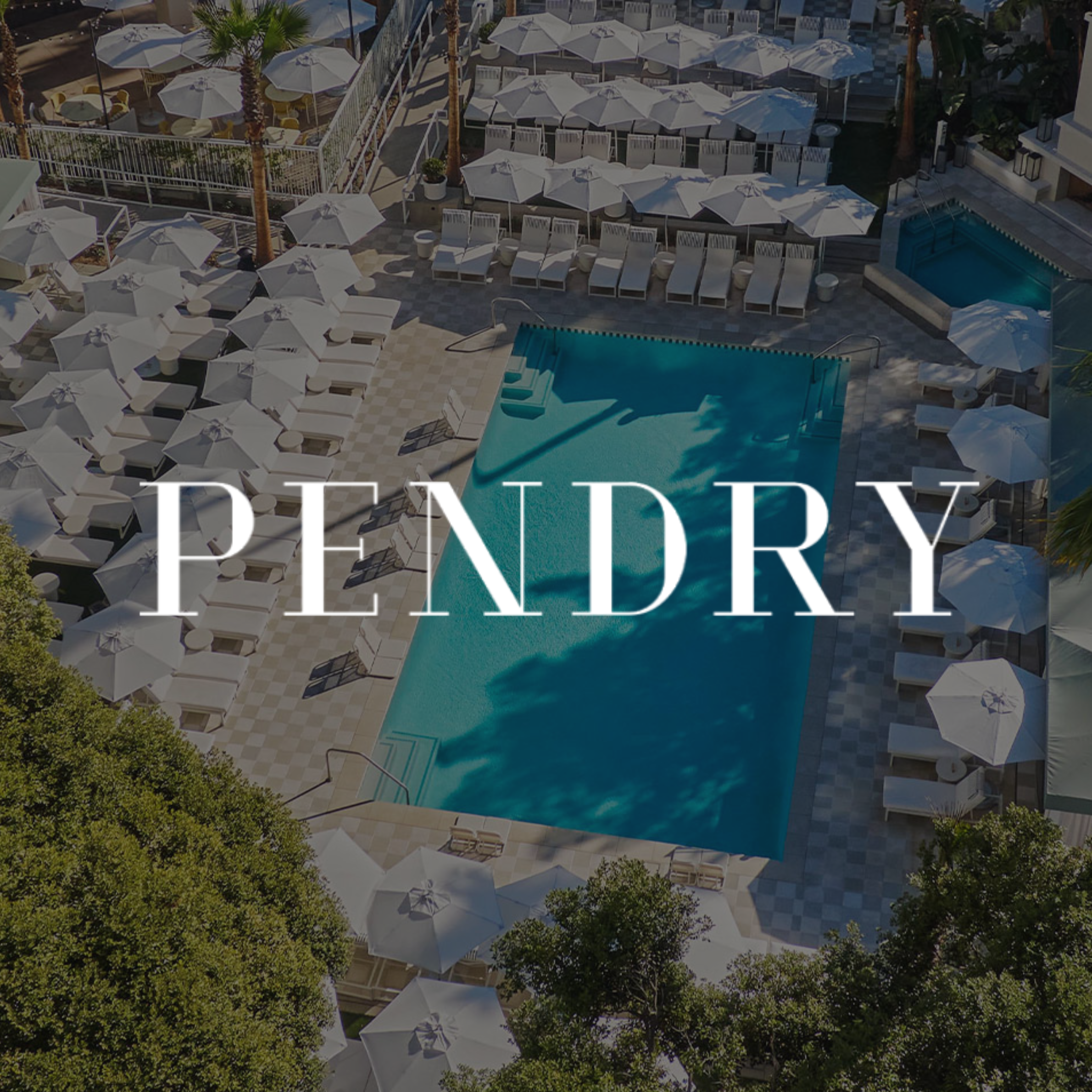 Aerial view of a hotel pool area with white umbrellas, lounge chairs, palm trees, and lush green trees surrounding the area.
