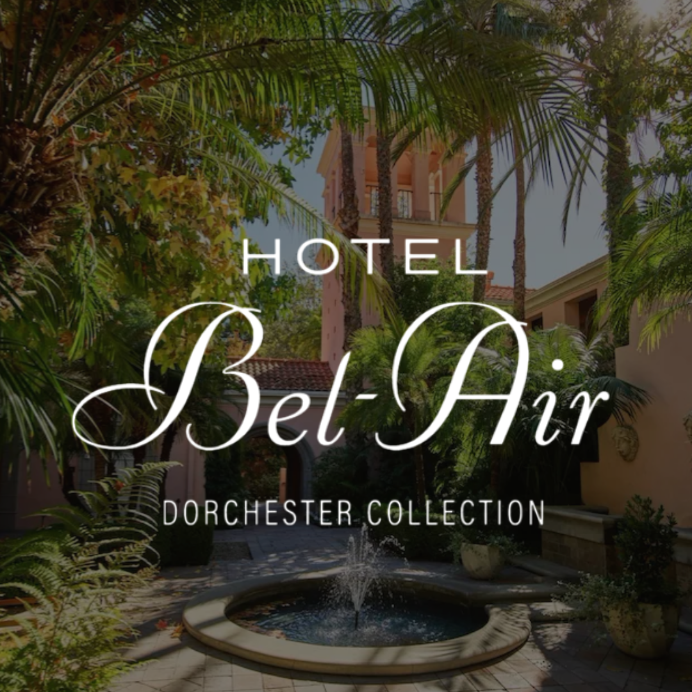 A fountain in a garden surrounded by green palm trees and other plants, with a building in the background. The image also contains text that reads "HOTEL" and "SELECT HOTEL".