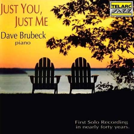 Album cover titled "Just You, Just Me" by Dave Brubeck featuring a sunset scene with two empty Adirondack chairs overlooking a lake or ocean, silhouetted trees, and a TELARC logo in the top right corner.