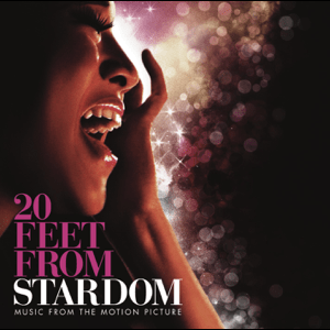 Close-up of a woman singing with her hand near her face, with sparkles and bokeh in the background. Text reads '20 Feet From Stardom' and 'Music from the Motion Picture'.