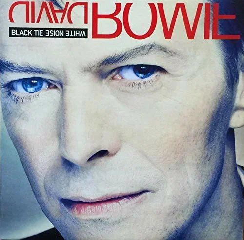 Close-up of David Bowie's face with piercing blue eyes, with text that reads 'BOWIE' and 'WHITE NOISE LIVE' on the cover.