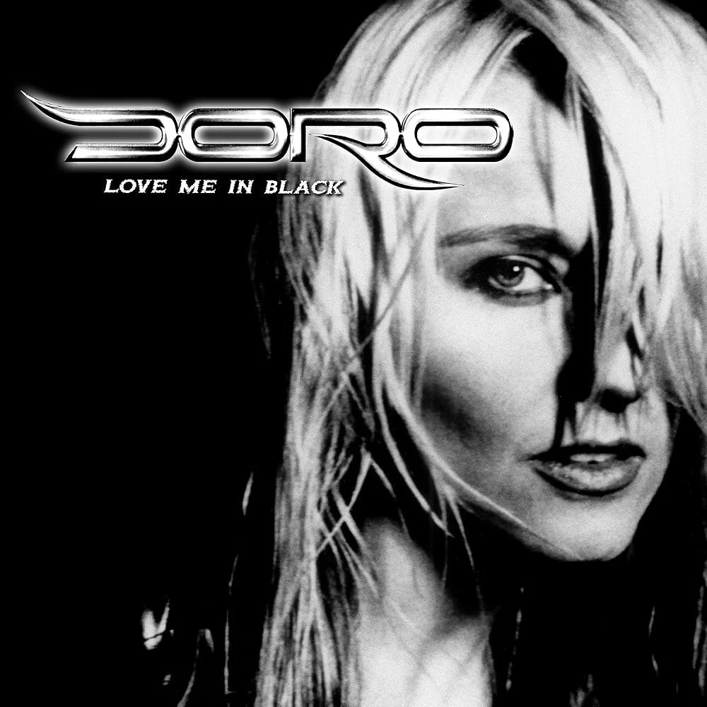Black and white album cover with a partial portrait of a woman with long blonde hair, the name 'DORO' in stylized text and the album title 'Love Me In Black'.