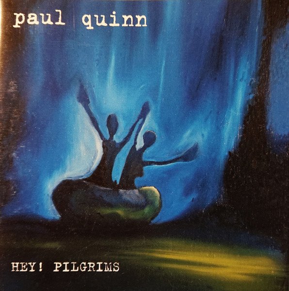 Album cover featuring silhouettes of two people with raised arms in a canoe-like boat against a blue background, with text 'paul quinn' at the top and 'HEY! PILGRIMS' at the bottom.