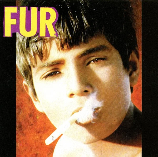 A young person with dark hair smokes a cigarette, with smoke visible near their face. The background is reddish-orange, and the word 'FUR' appears in large yellow and purple letters in the top left corner.