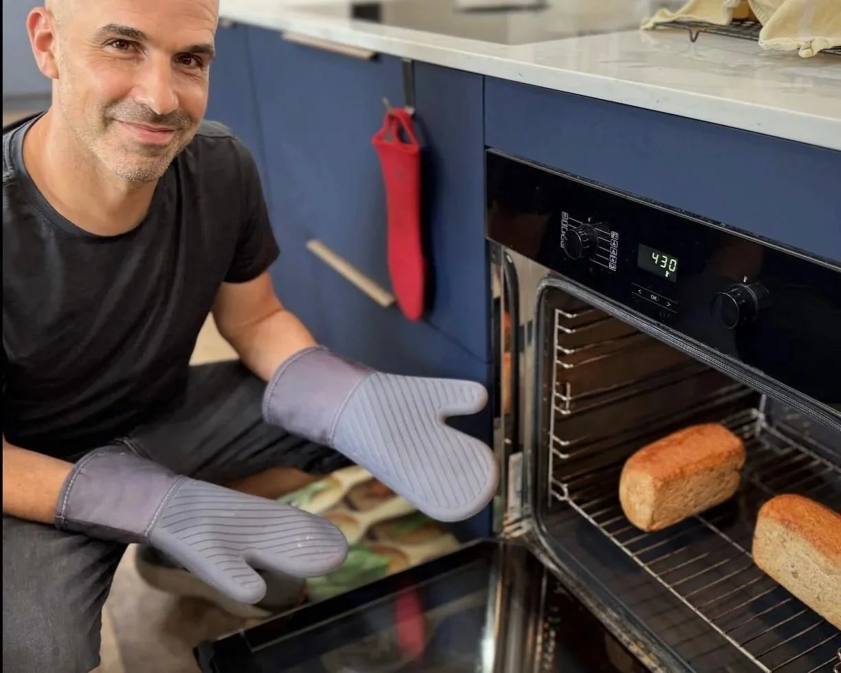 Roy baking fresh sourdough bread during a beginner baking workshop