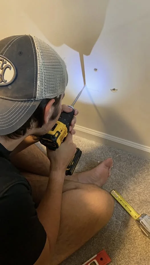 Tony teaching his son Ben how to work on a home project, representing the purpose behind The Connected Handyman Co. and its support for mental health awareness and suicide prevention.