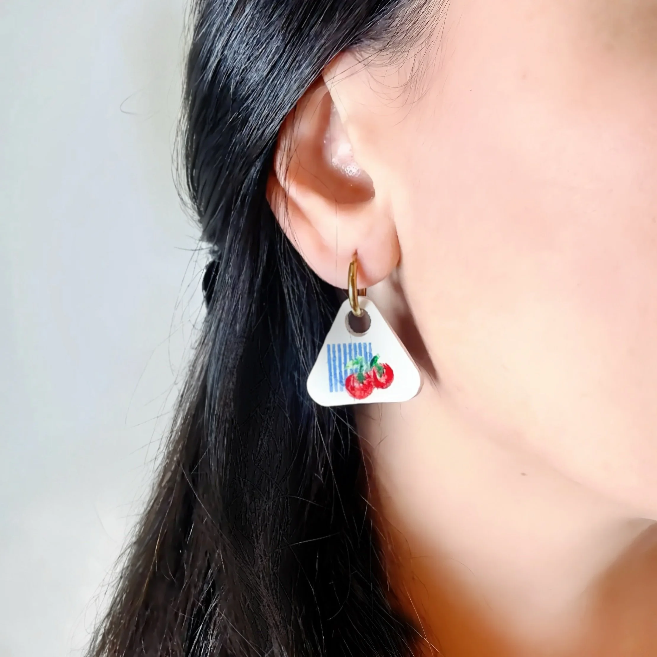 paloma-clay-model-wearing-cherry-print-triangle-dangle-earring.jpeg