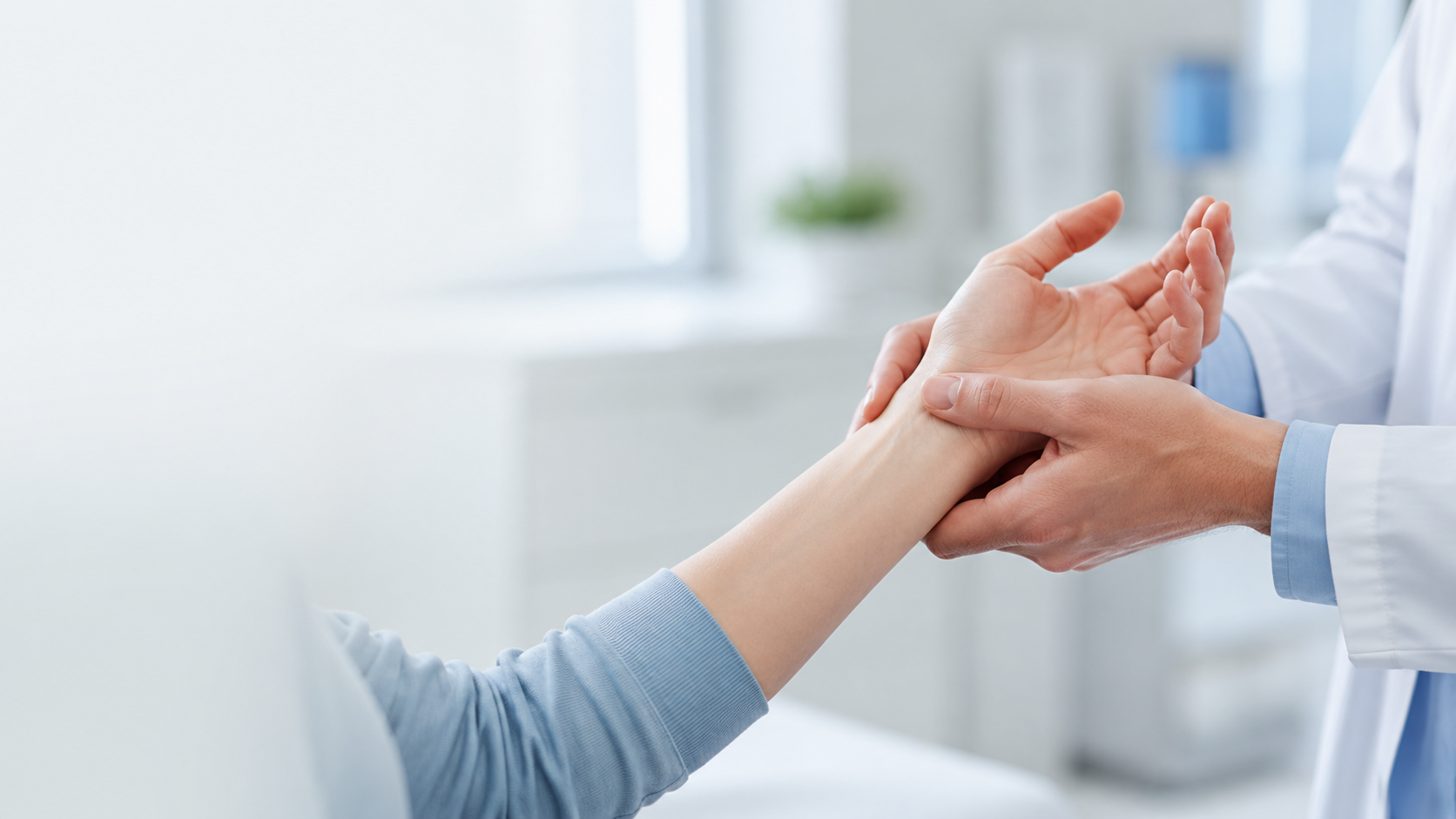 Image of someone having wrist examined by doctor