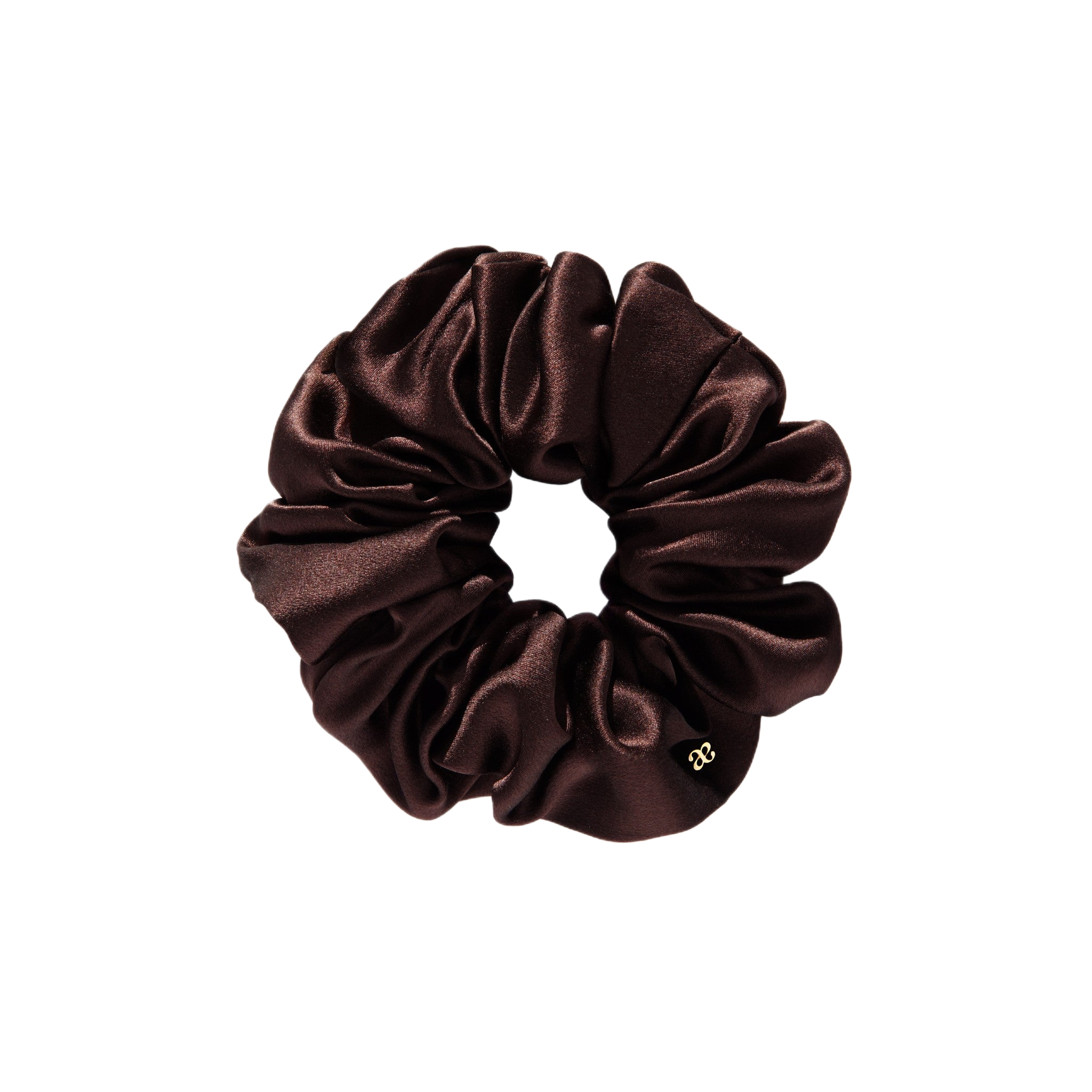 A brown scrunchie made of satin fabric placed on a white background.