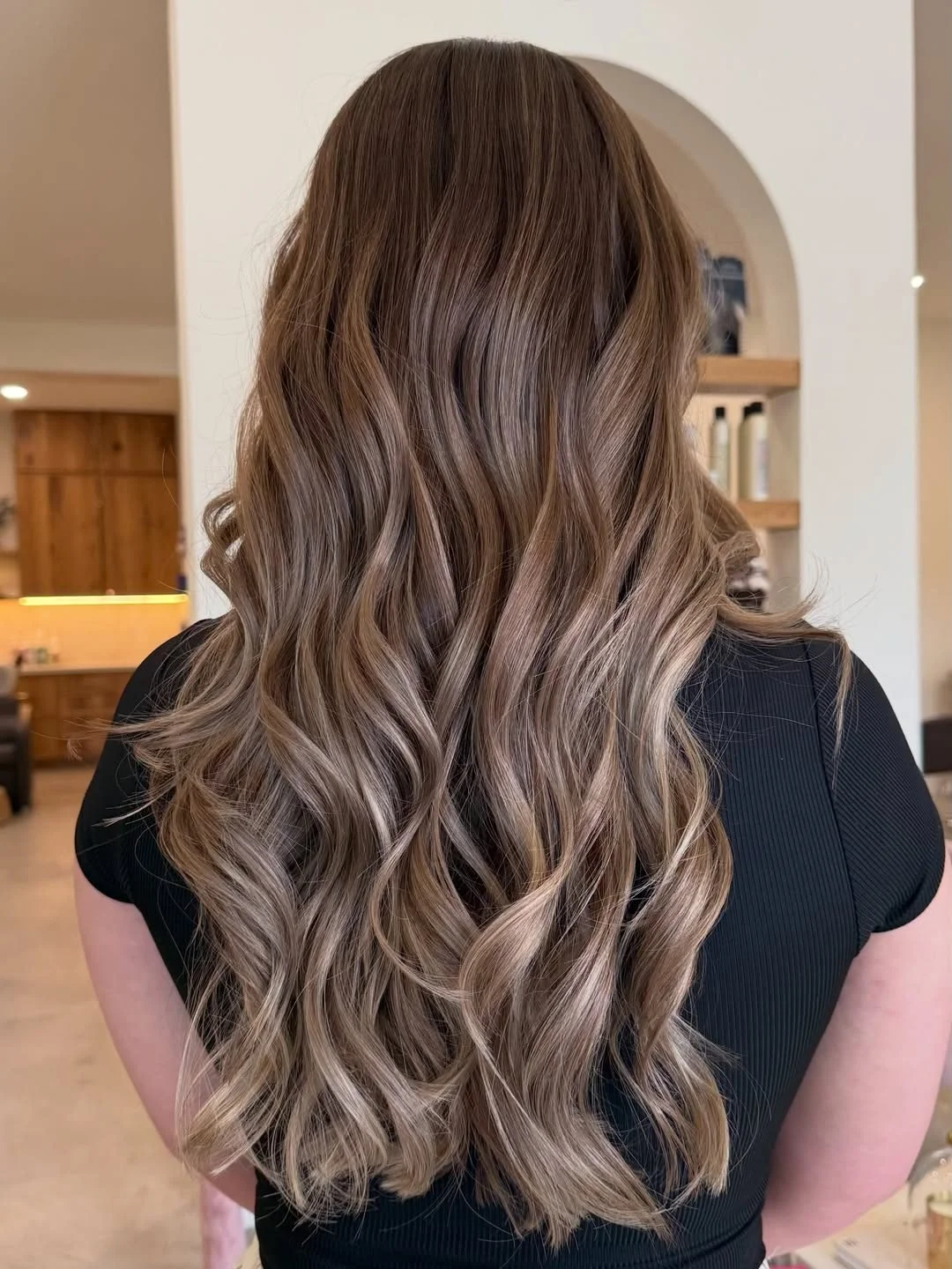 Long bronde balayage with soft hand-painted blonde ends, created by a         Tomball hair colorist at Lotus Boutique Salon.