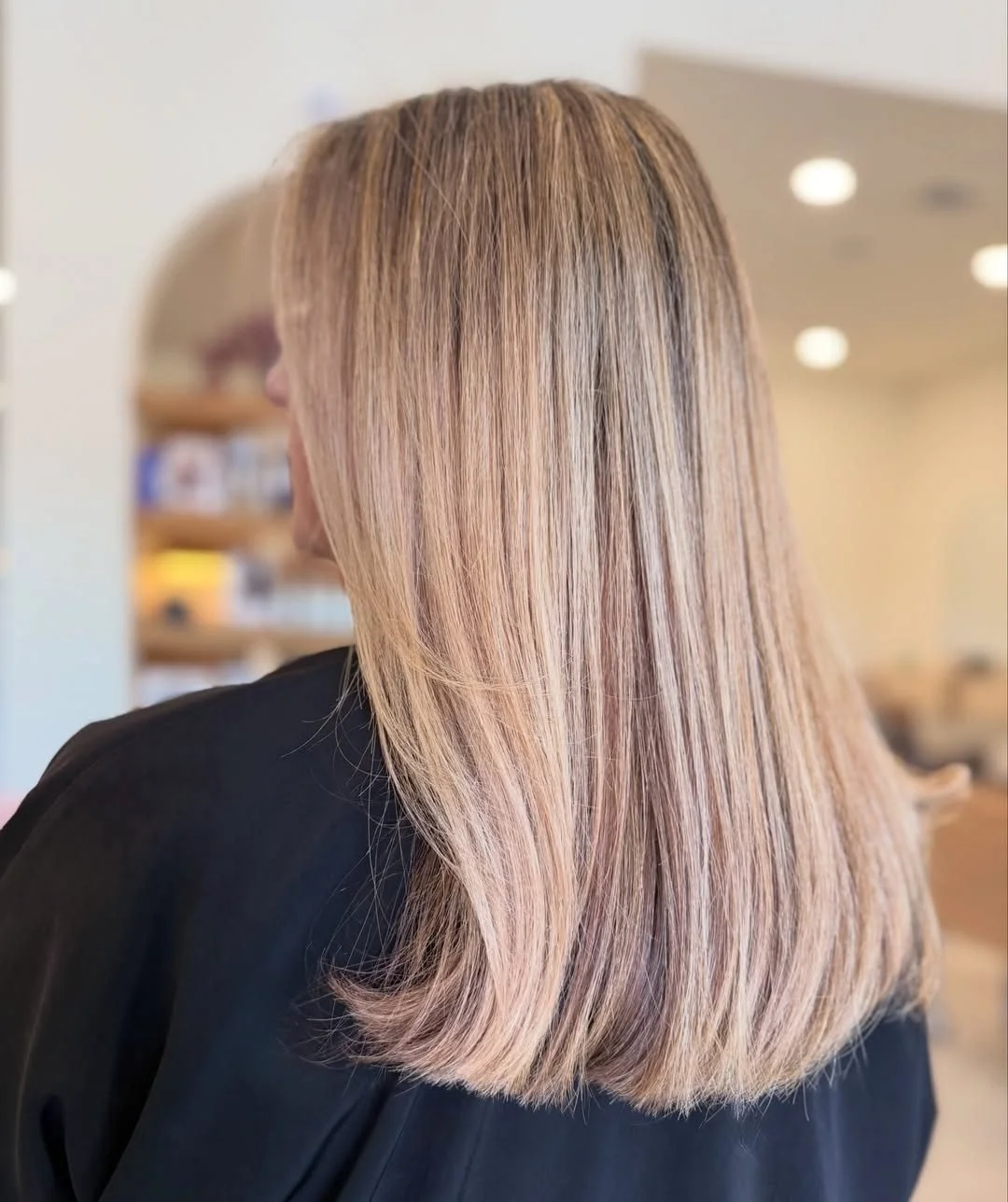 Shoulder-length blonde hair with partial foil highlights, brightened and glossed at a hair salon in Tomball, TX.