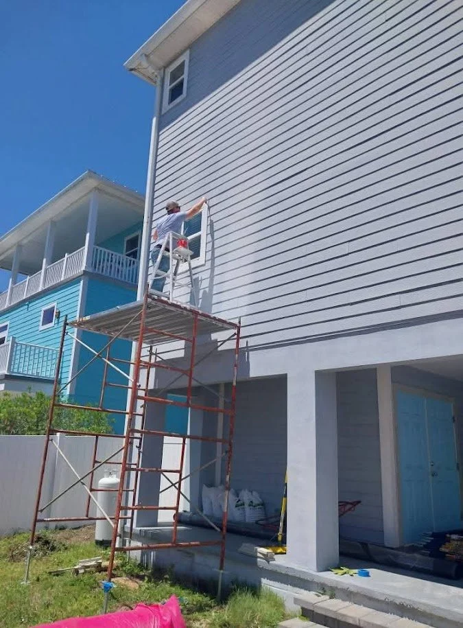 caulking primeing painting new harddie board trim around the windows on st.augustine 