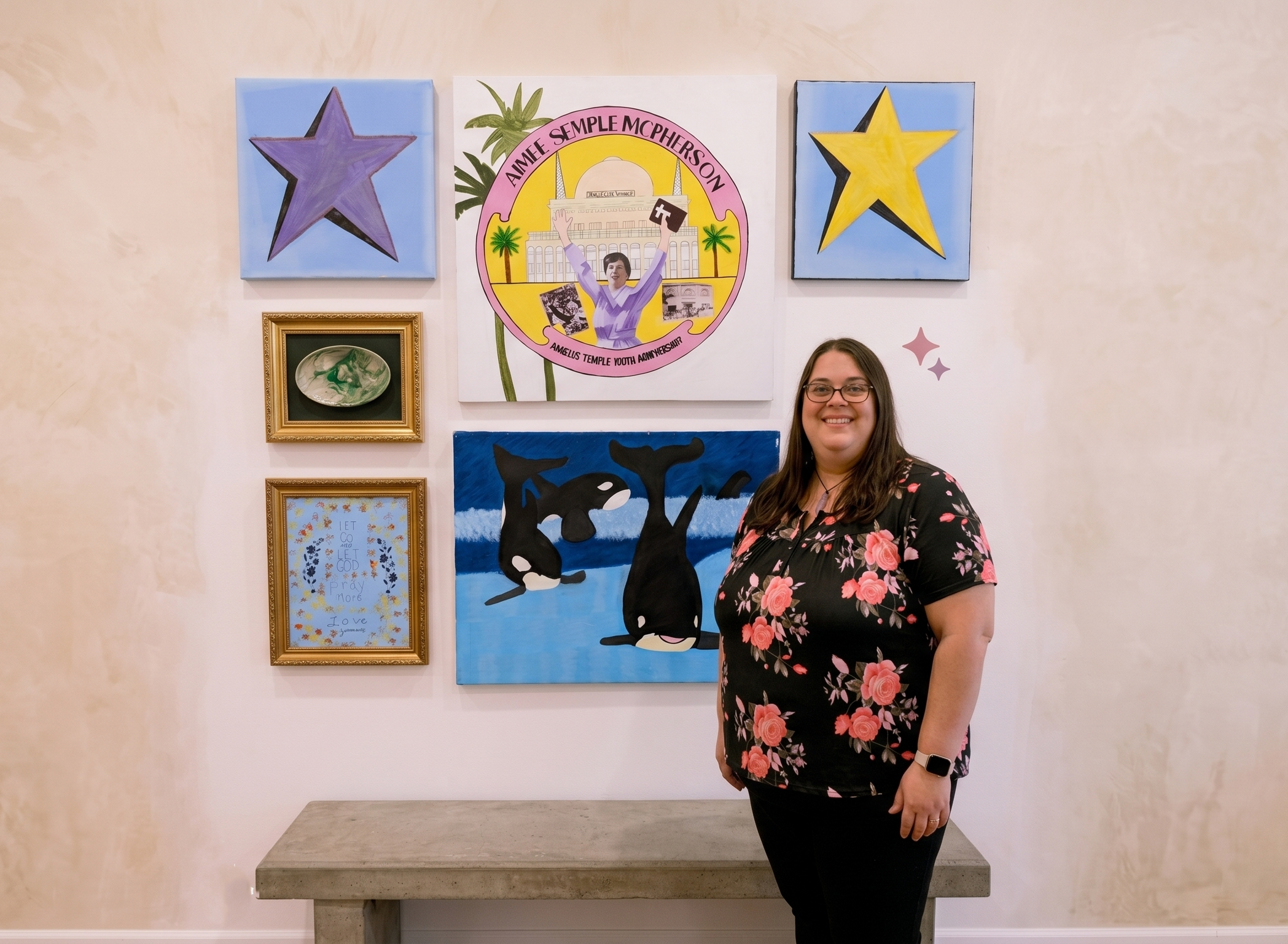 A woman with glasses and a floral shirt standing in front of a wall decorated with vibrant artwork, including a circular poster of a young person holding a cross and raising their arms, with the caption 'AIMEE SEMPLE MCPHERSOON' and images of a building, palm trees, and a sunset.