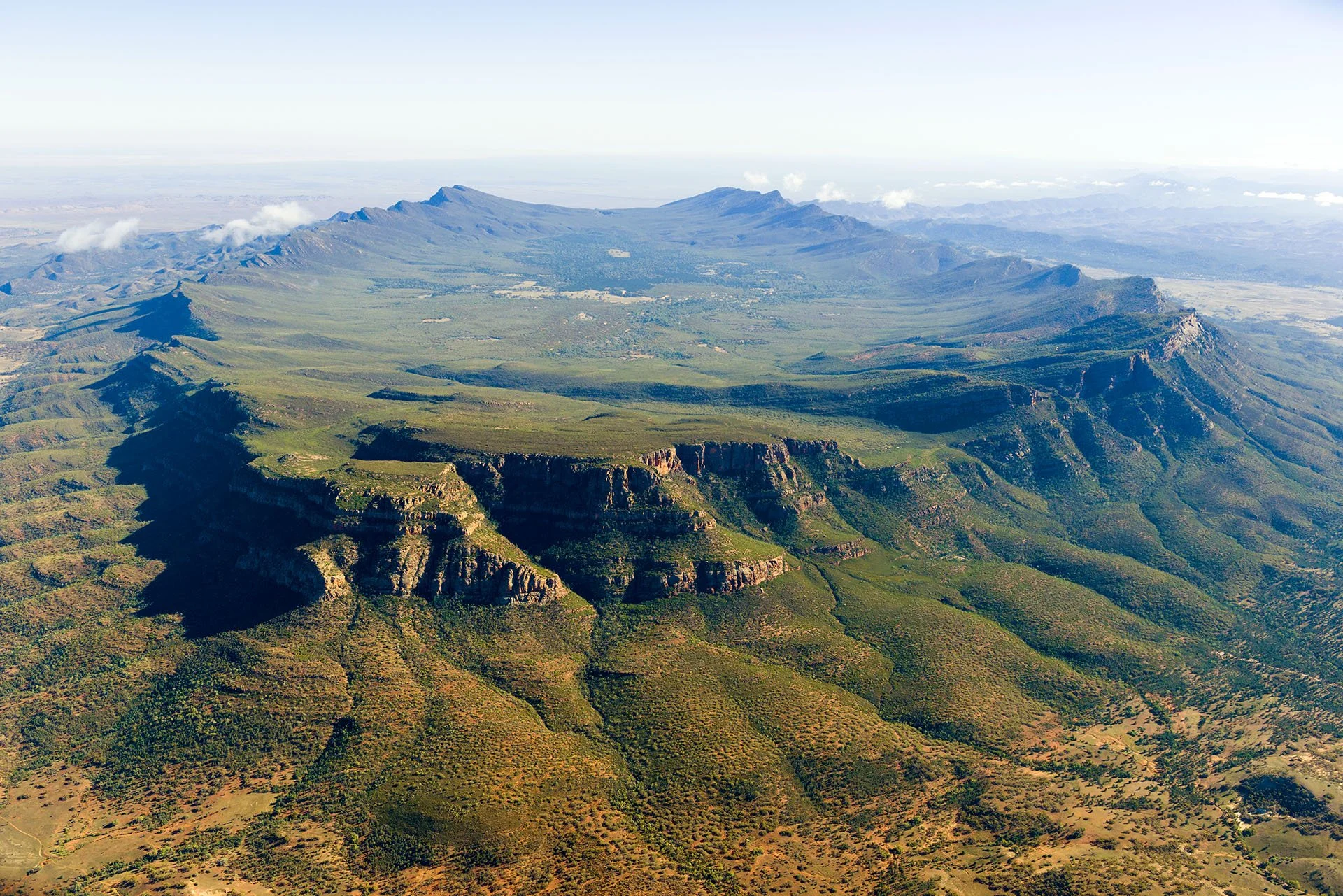 Aerial view of Wilpena Pound, a vast natural amphitheatre of mountains ringed by sheer cliffs in Ikara-Flinders Ranges National Park, South Australia.