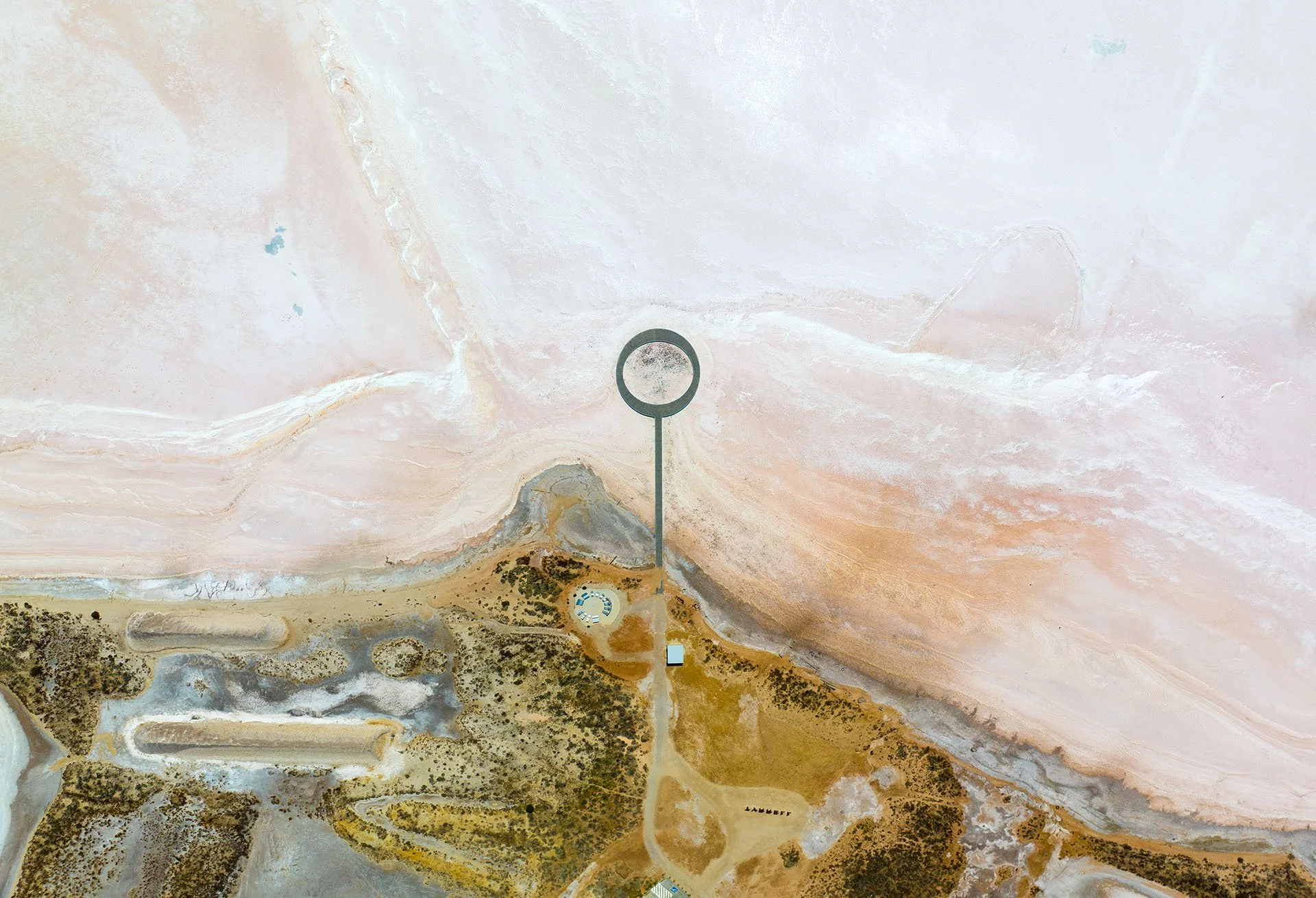 Drone view looking straight down on the circular viewing platform and boardwalk extending onto the pink and white salt crust of Lake Tyrrell, near Sea Lake, Victoria.