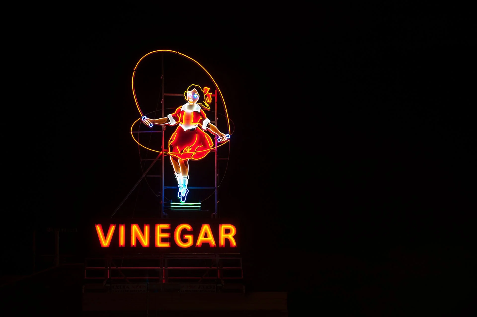 Vinegar neon sign in Abbotsford of a girl skipping rope