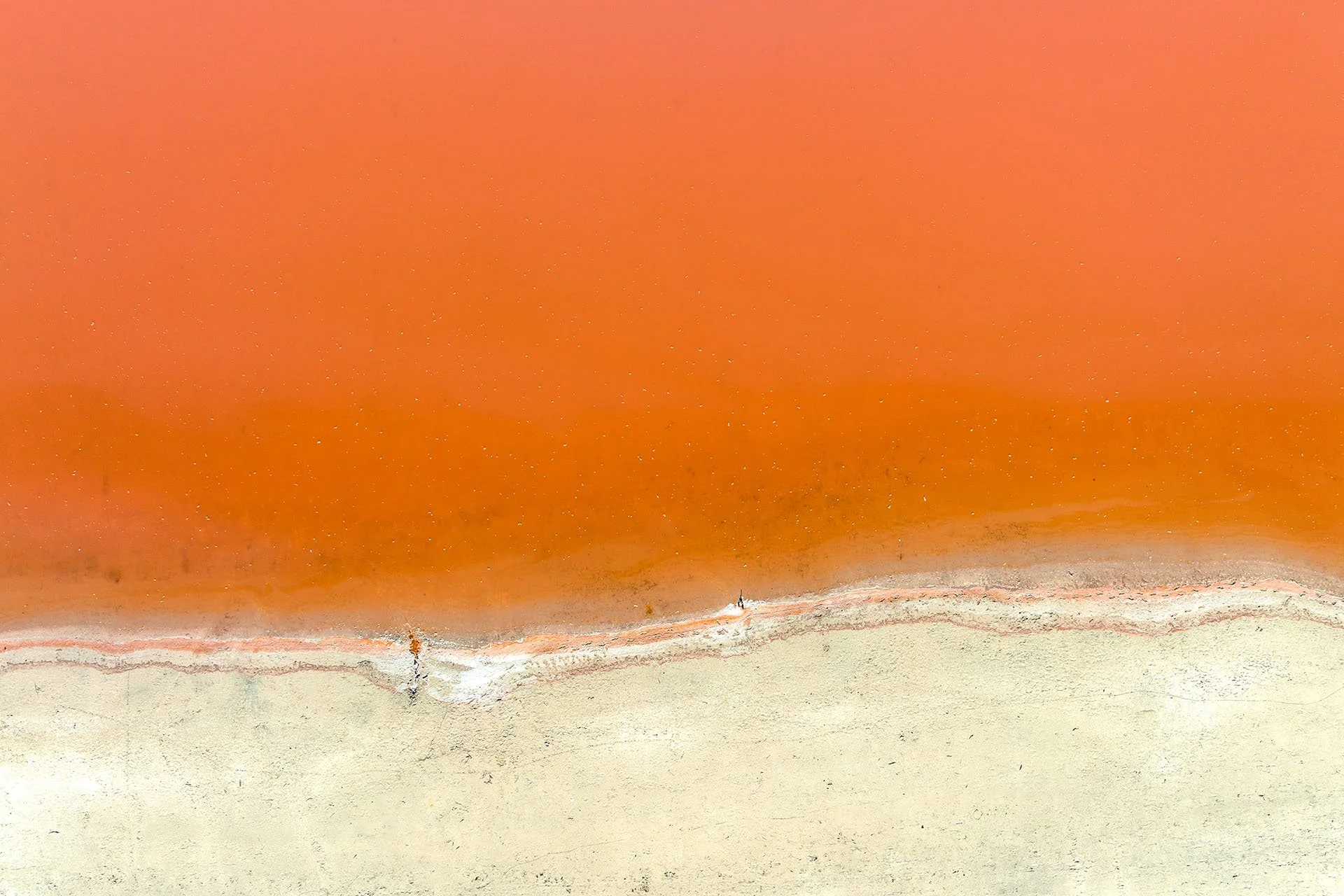 Aerial abstract of salt lake with orange and cream tones