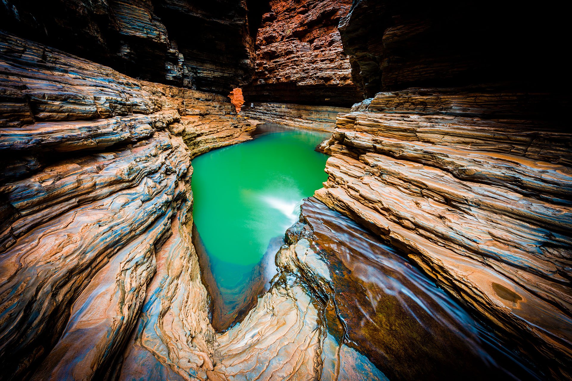 Green water in a red rock gorge