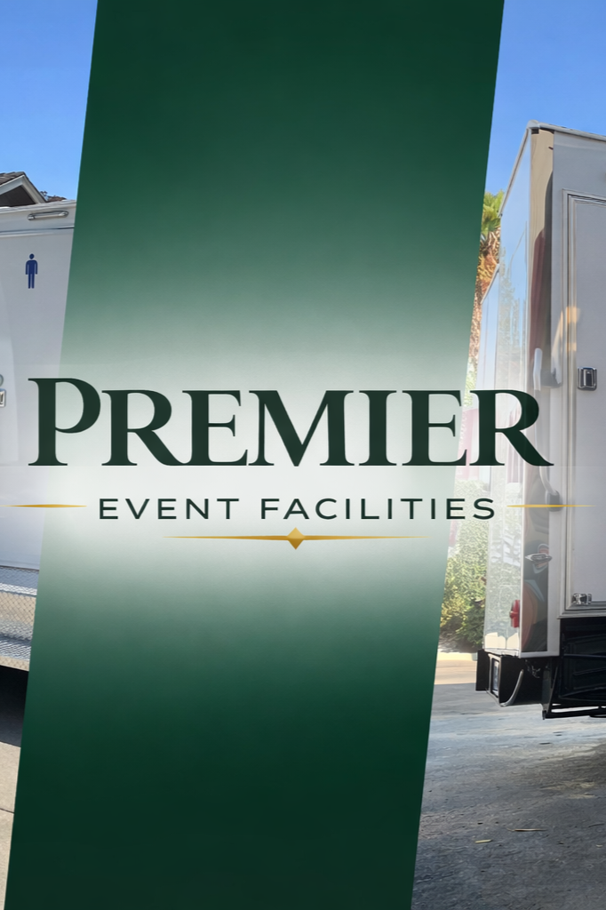A sign that says 'Premier Event Facilities' with a green and white background, positioned between two mobile trailers outside on a sunny day.