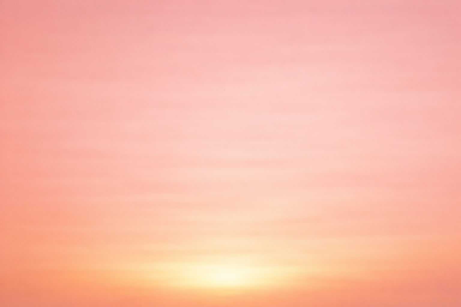 Soft blurred abstract background in warm peach and orange tones.