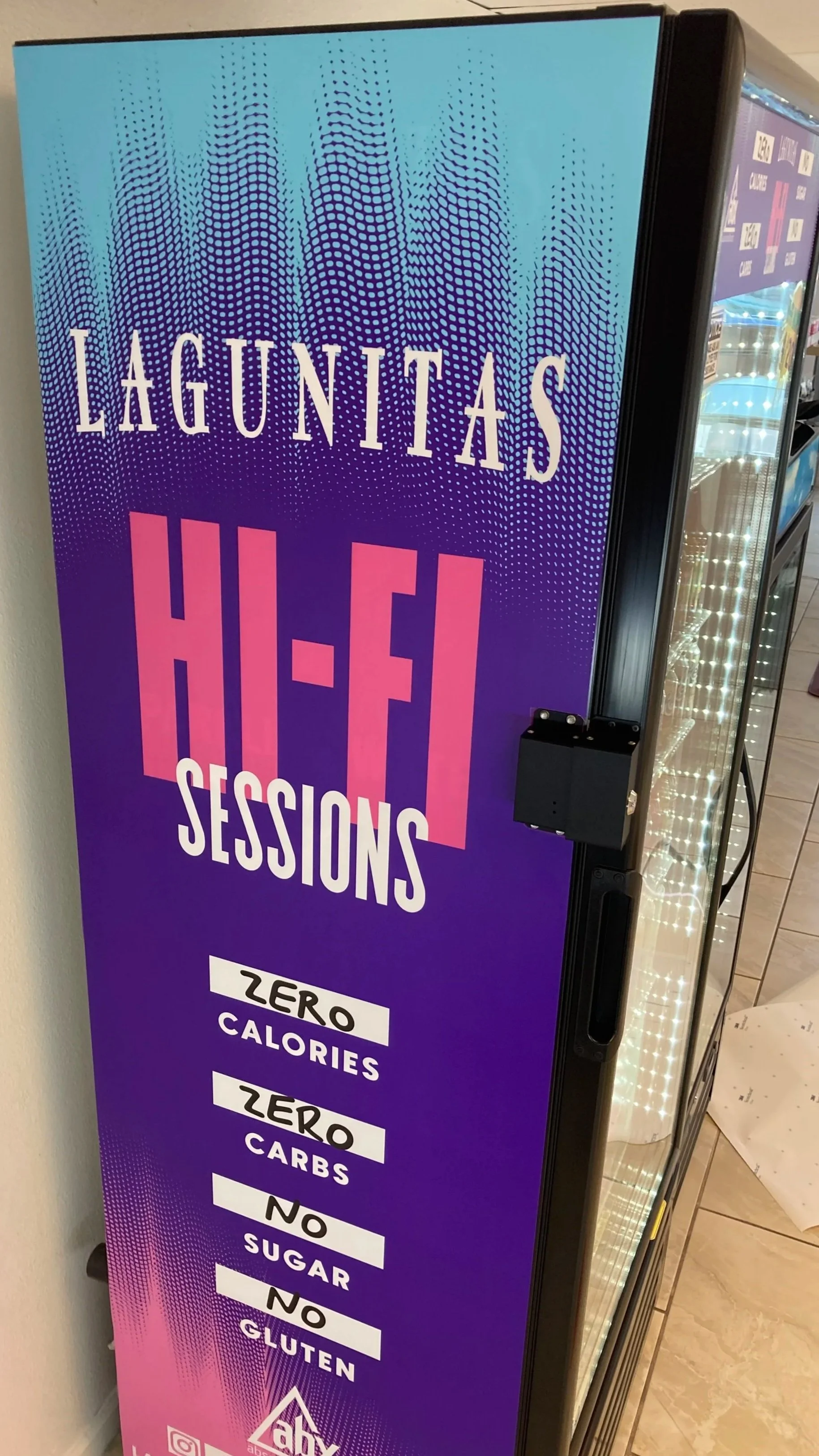 Poster advertising a no-calorie, no carbs, no sugar, no gluten Lagunitas H-E-I sessions with a colorful gradient background and digital design elements.