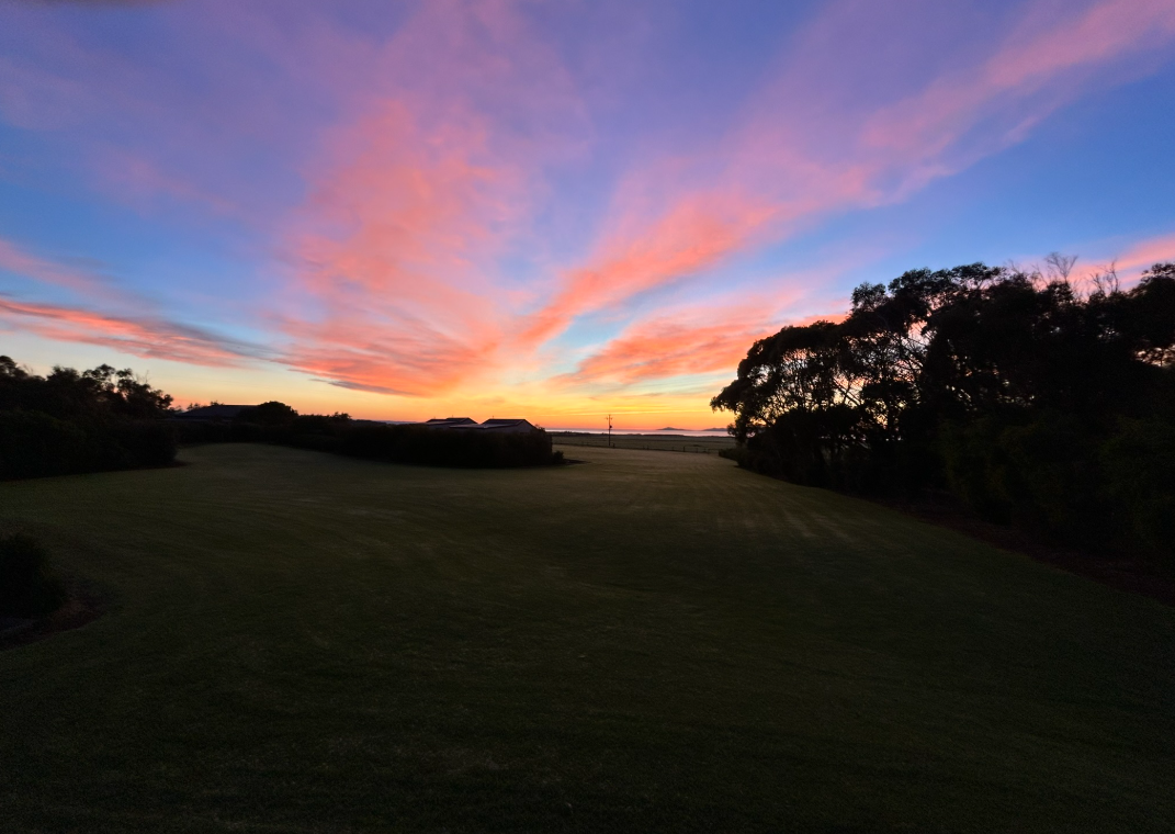 Sunset across open fields near Prom Gate Getaway and Wilsons Prom.