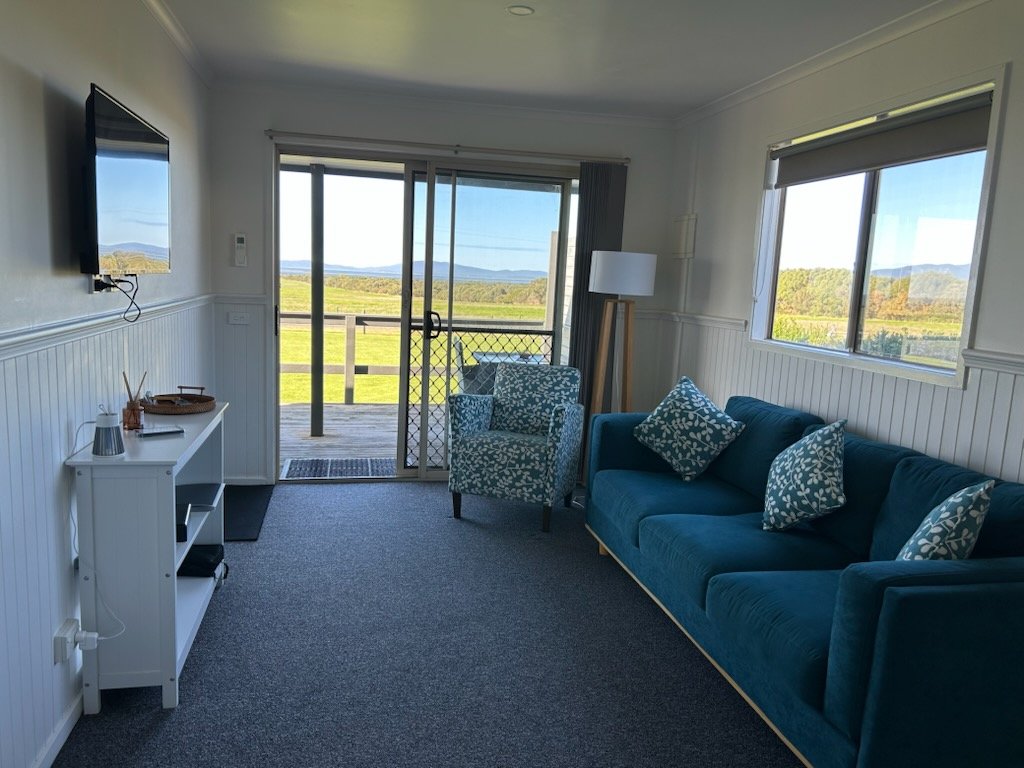 Living room with coastal views inside Prom Gate Getaway cabin near Wilsons Prom