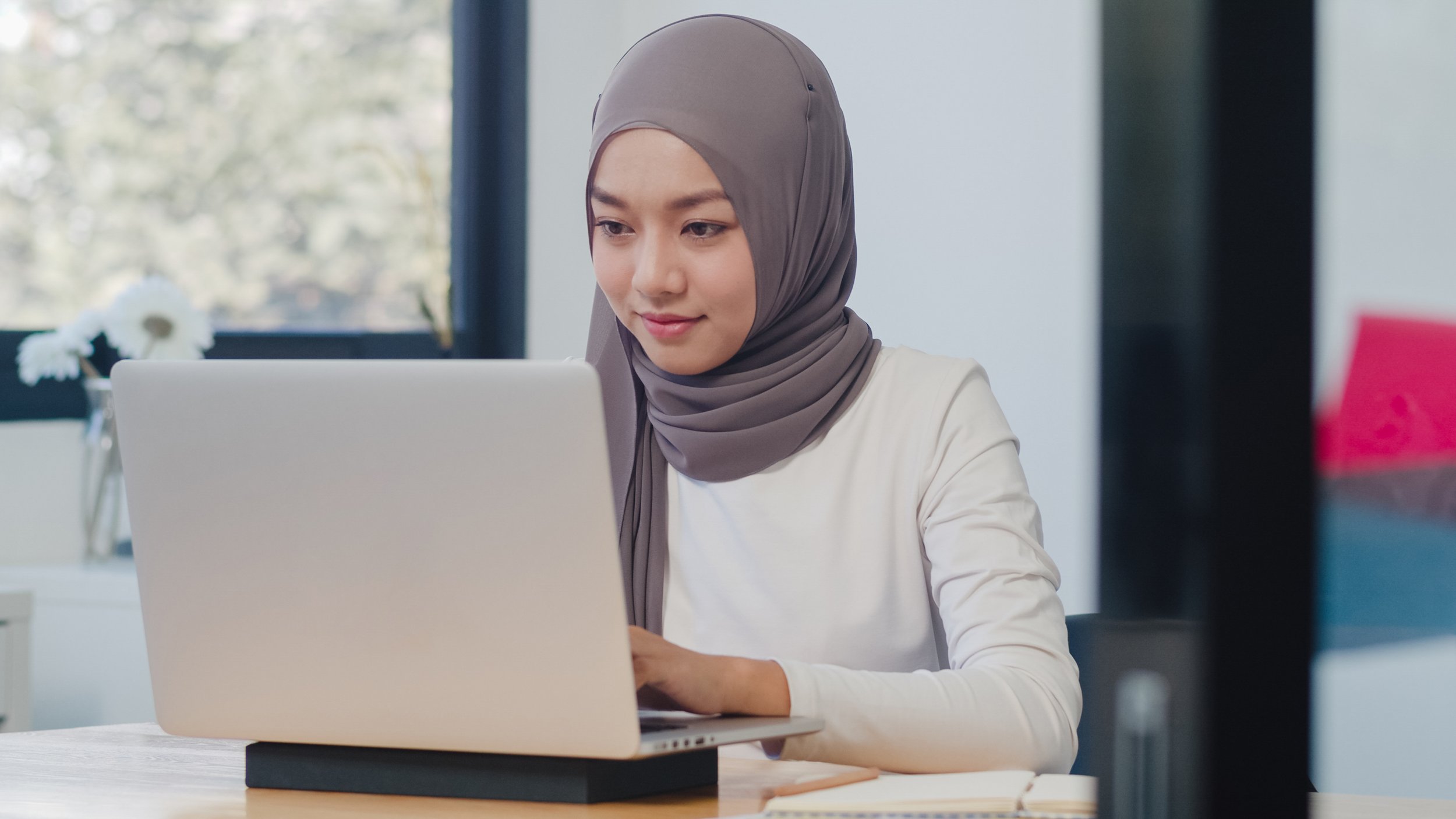 beautiful-asian-muslim-lady-casual-wear-working-using-laptop-modern-new-normal-office.jpg