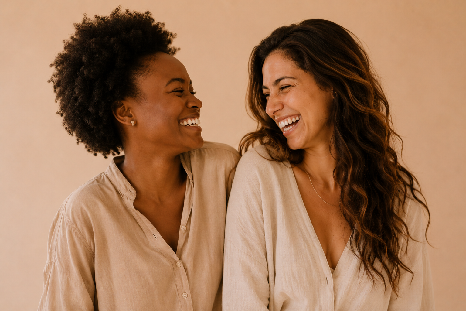 Two women sitting together laughing