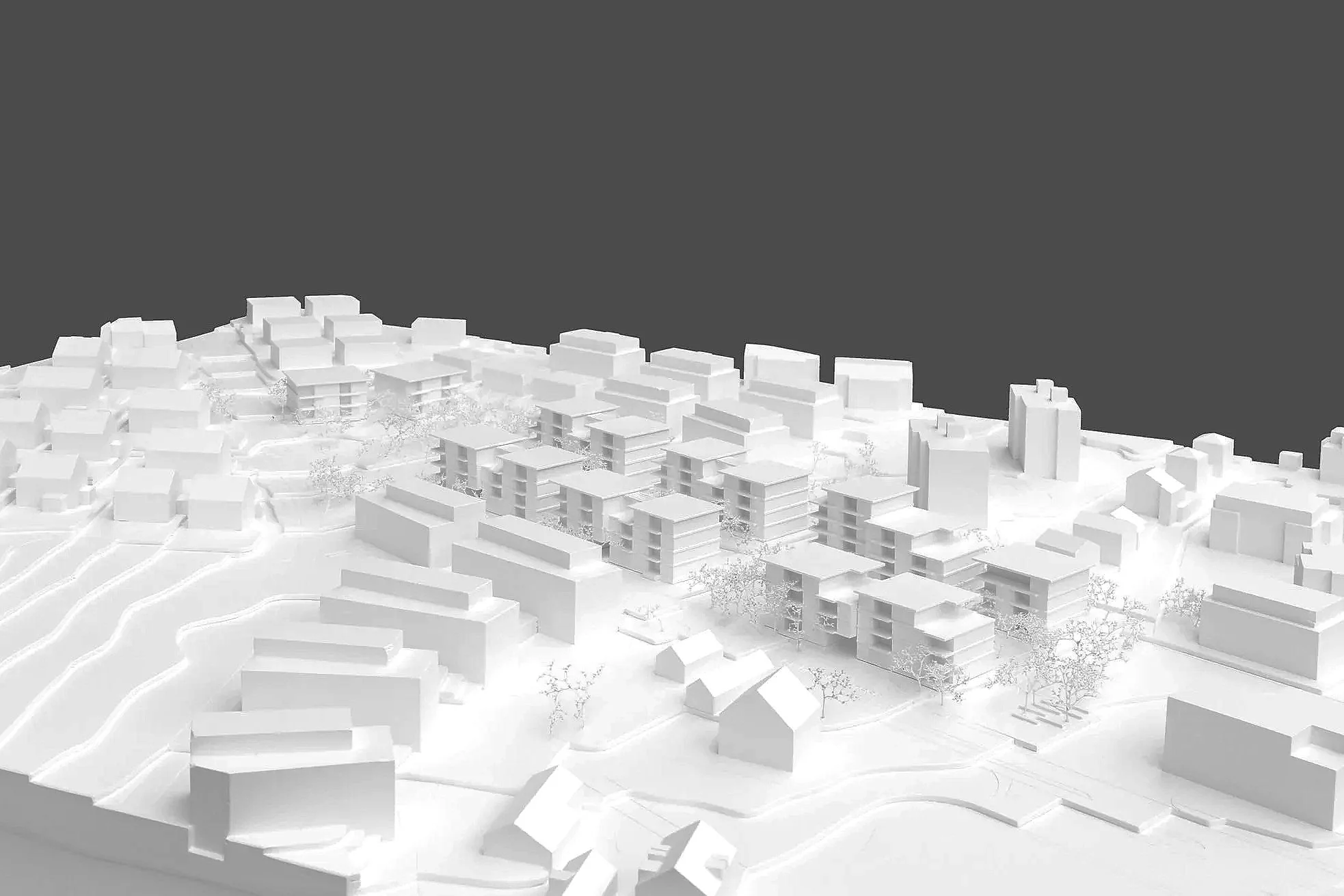 Ein weißer Modell-Architektur-Entwurf eines Stadtviertels mit mehreren Gebäuden auf einem Modellgrundstück.