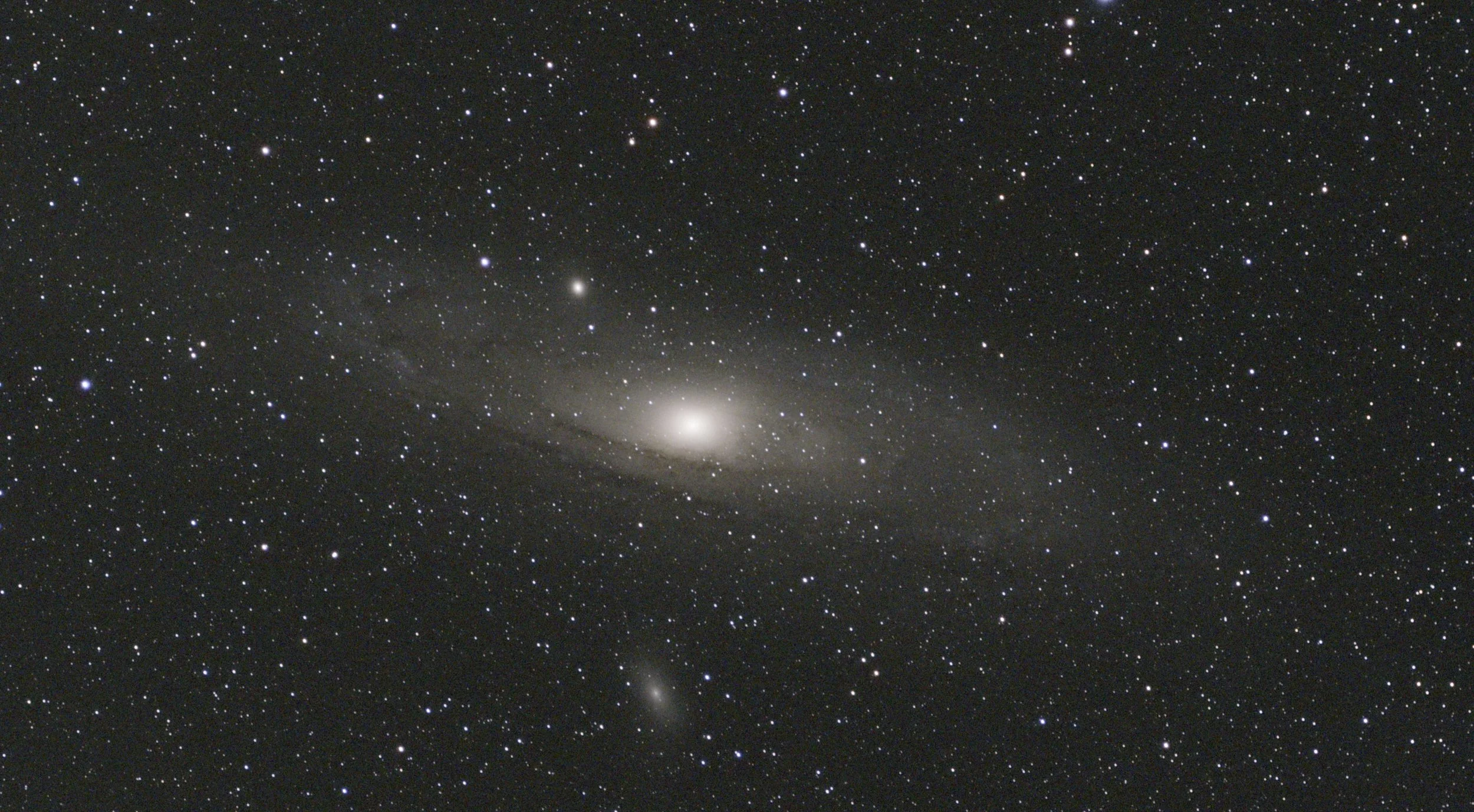 A detailed image of the Andromeda galaxy filled with countless stars and cosmic dust, showcasing its spiral arms.