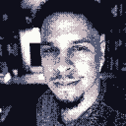 Pixel art image of a smiling young man with short hair making a peace sign near his face.
