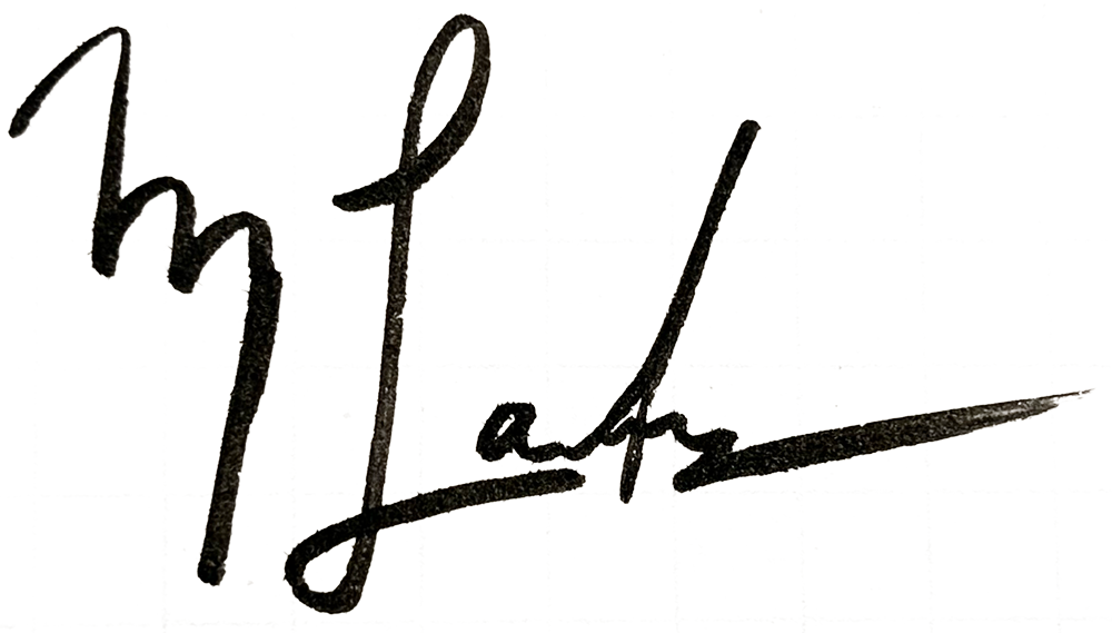 Close-up of a handwritten signature on a transparent or reflective surface.