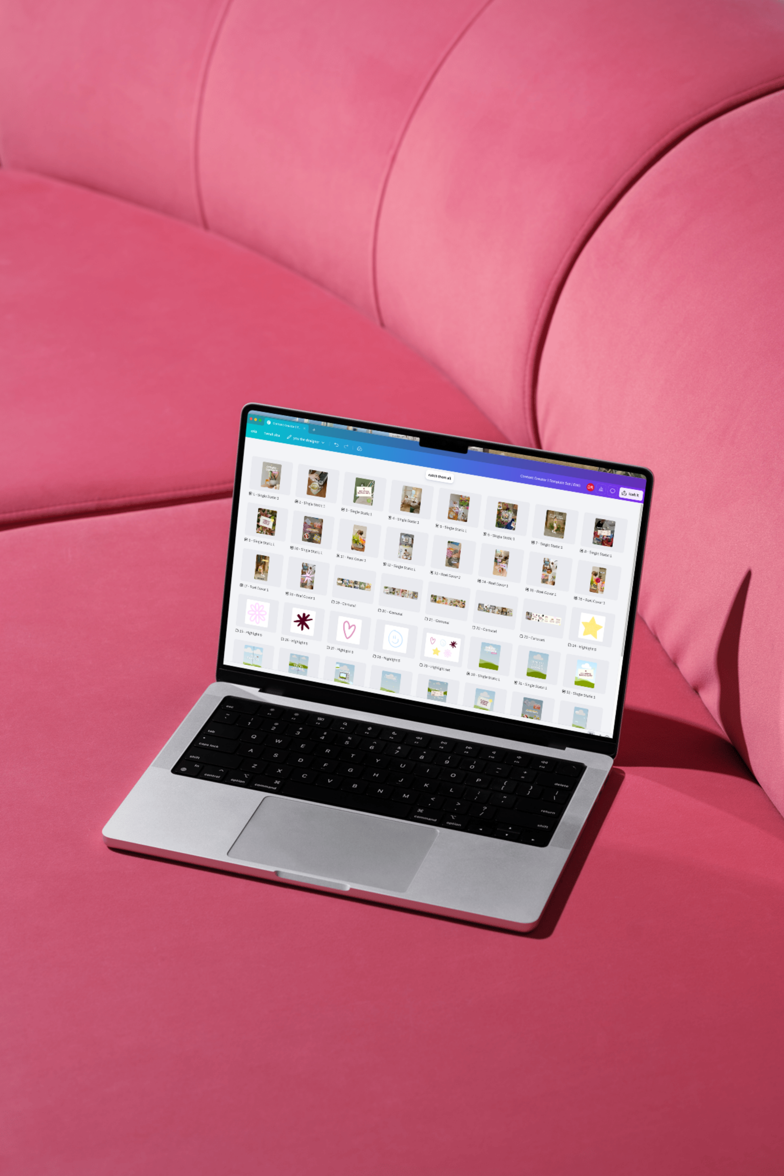 A silver laptop on a pink surface showing a grid of templates in Canva on its screen.