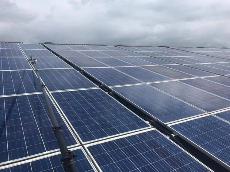 Solar panels installed on a cloudy day.