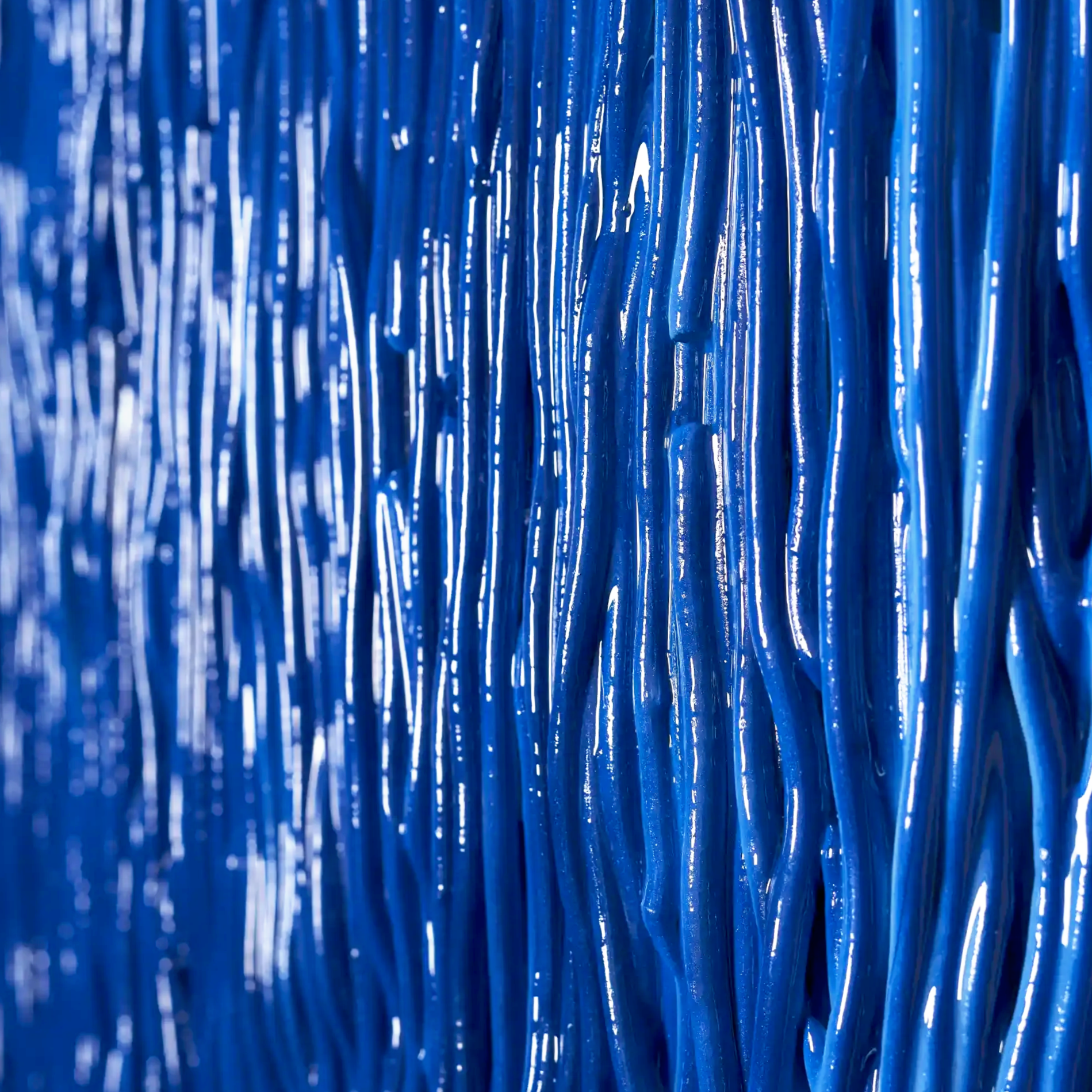 Close-up of a plaster blue epoxy mixed media wall sculpture art.