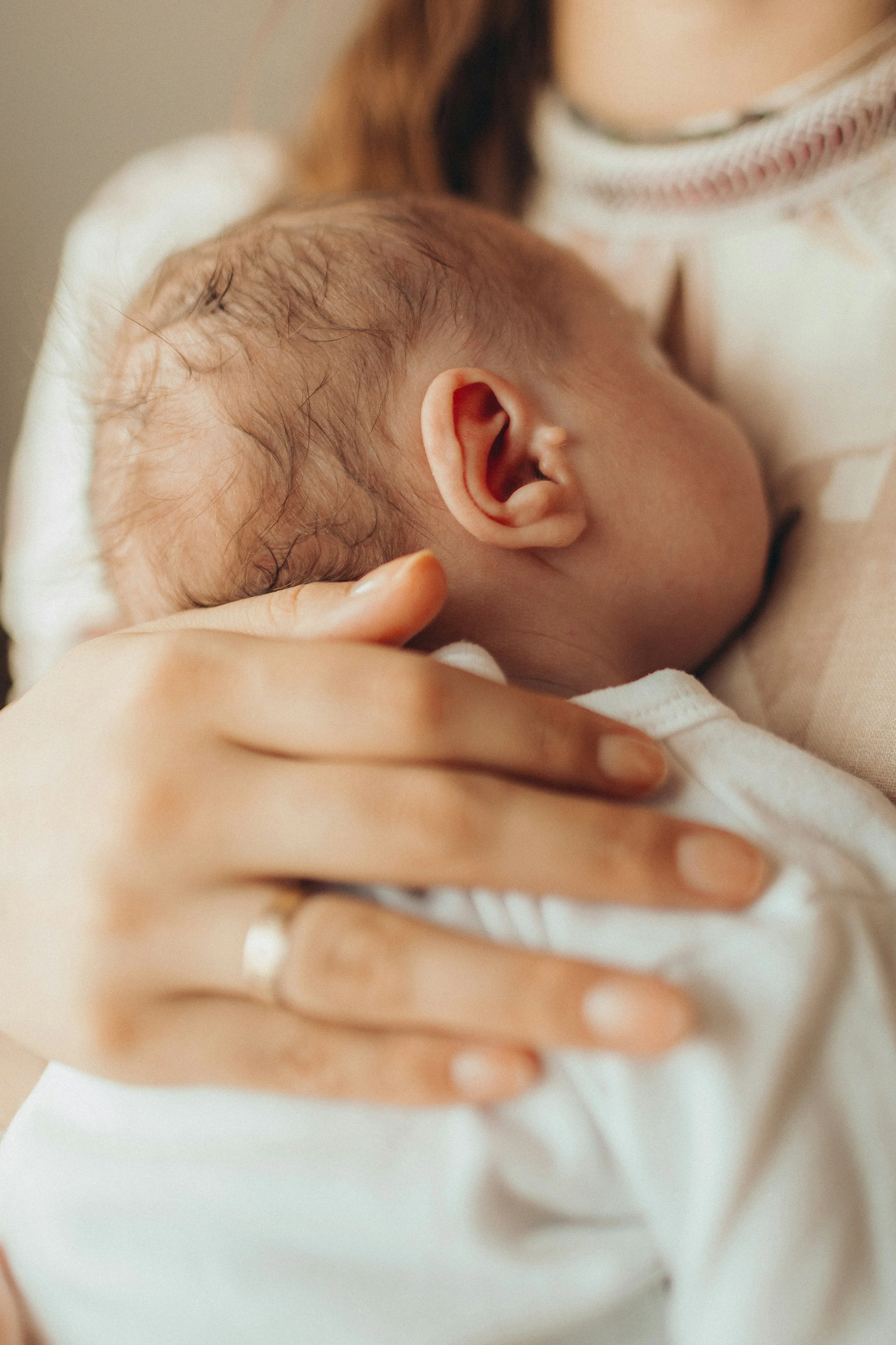 Close up of newborn baby being held