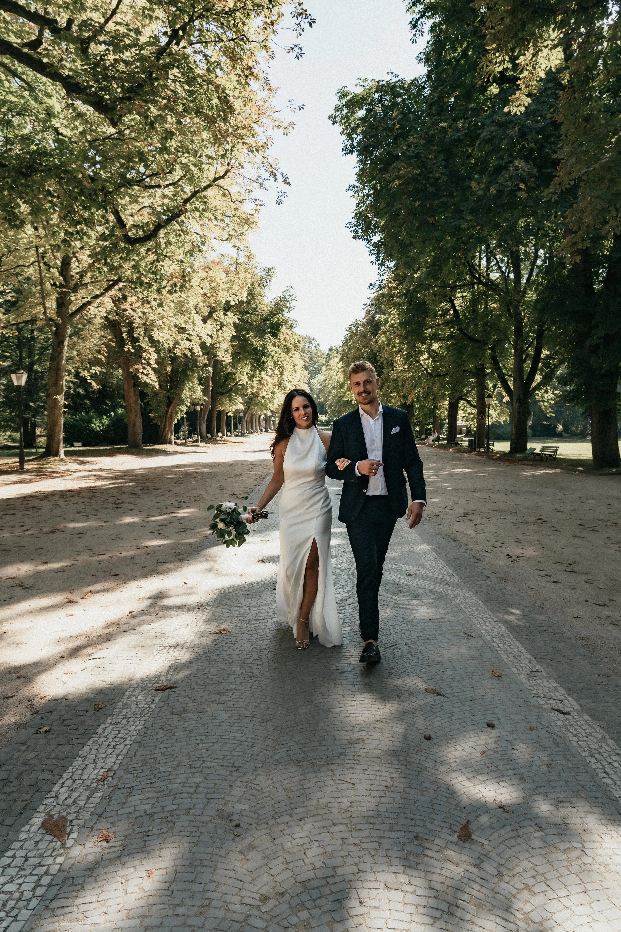 Bride and groom walking side by side in natural light in the park, captured by wedding photographer Jessica Di Salvo.
