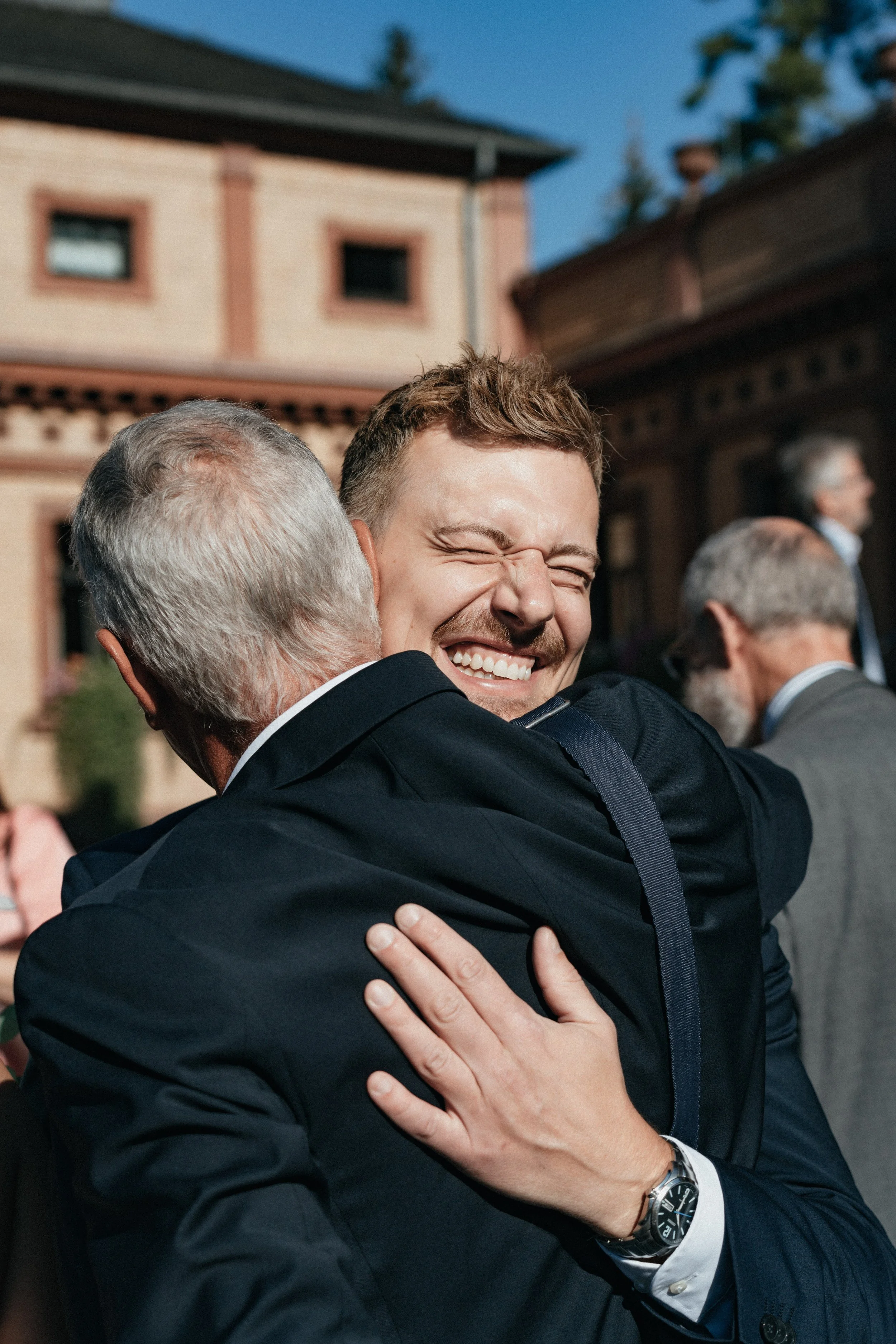 Emotional groom receives best wishes by wedding guest, Bad Homburg.