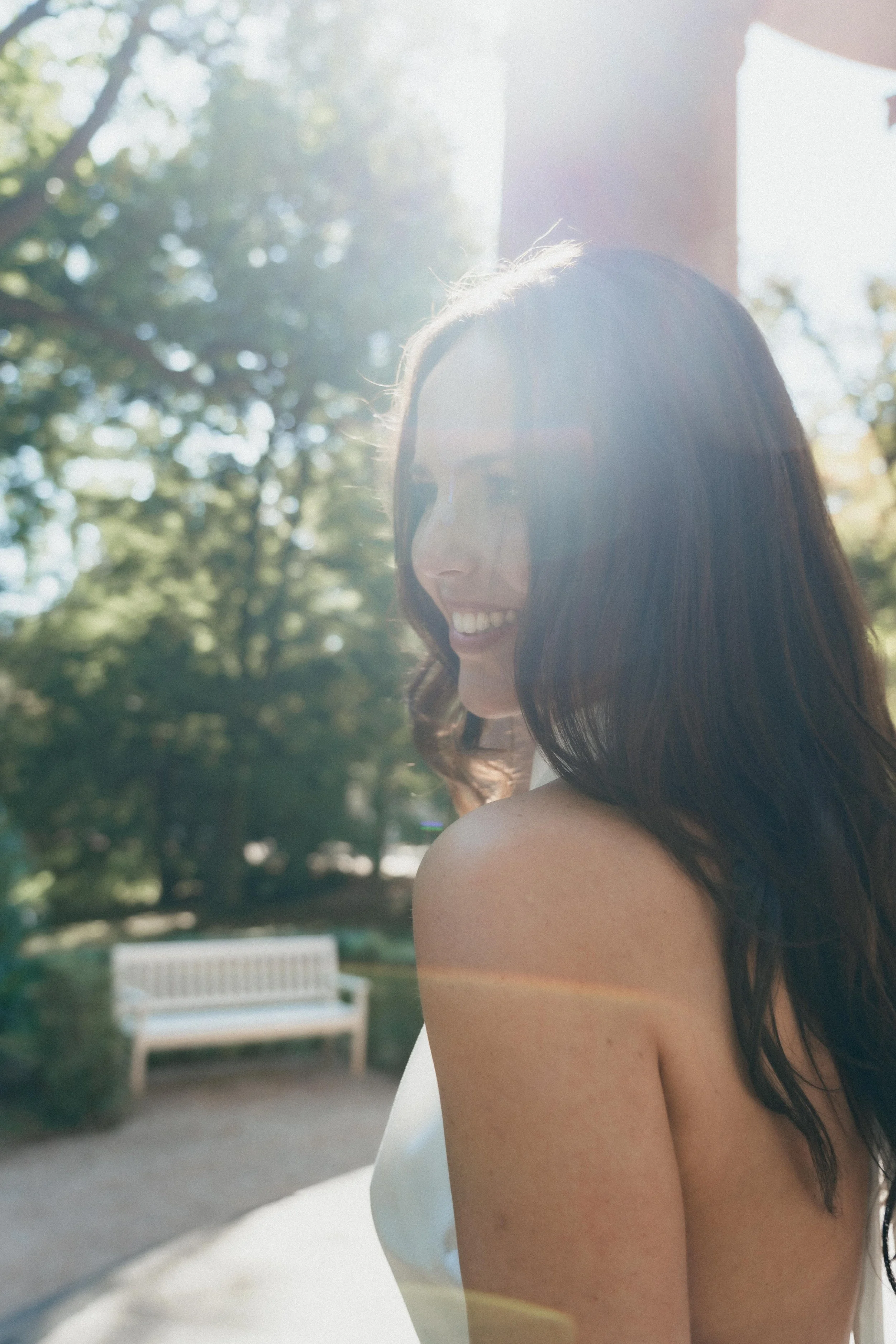 Portrait of smiling bride in golden light, Bad Homburg Parc, Germany.
