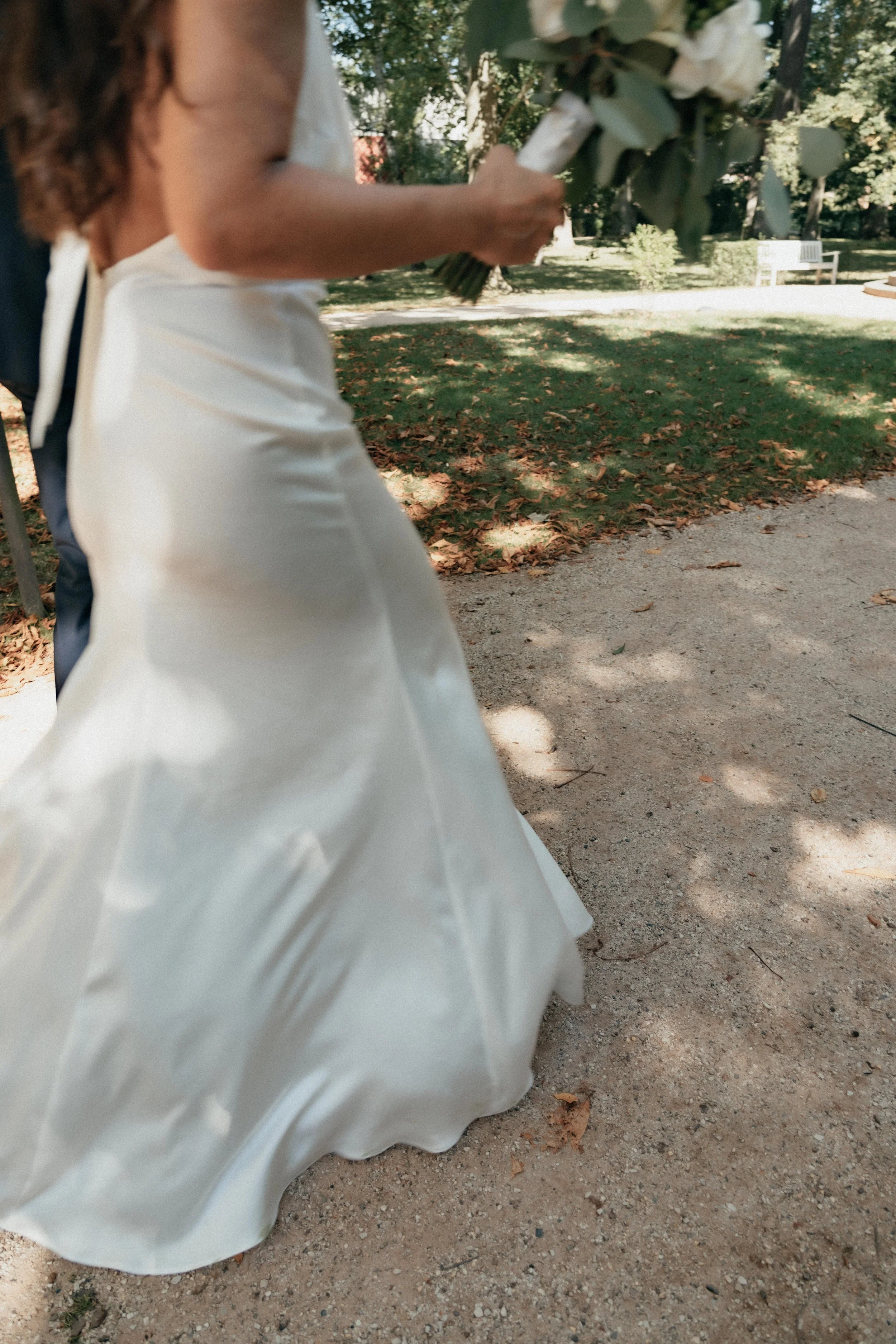 Detailed pictured of wedding gown in motion in Kurpark in Bad Homburg.