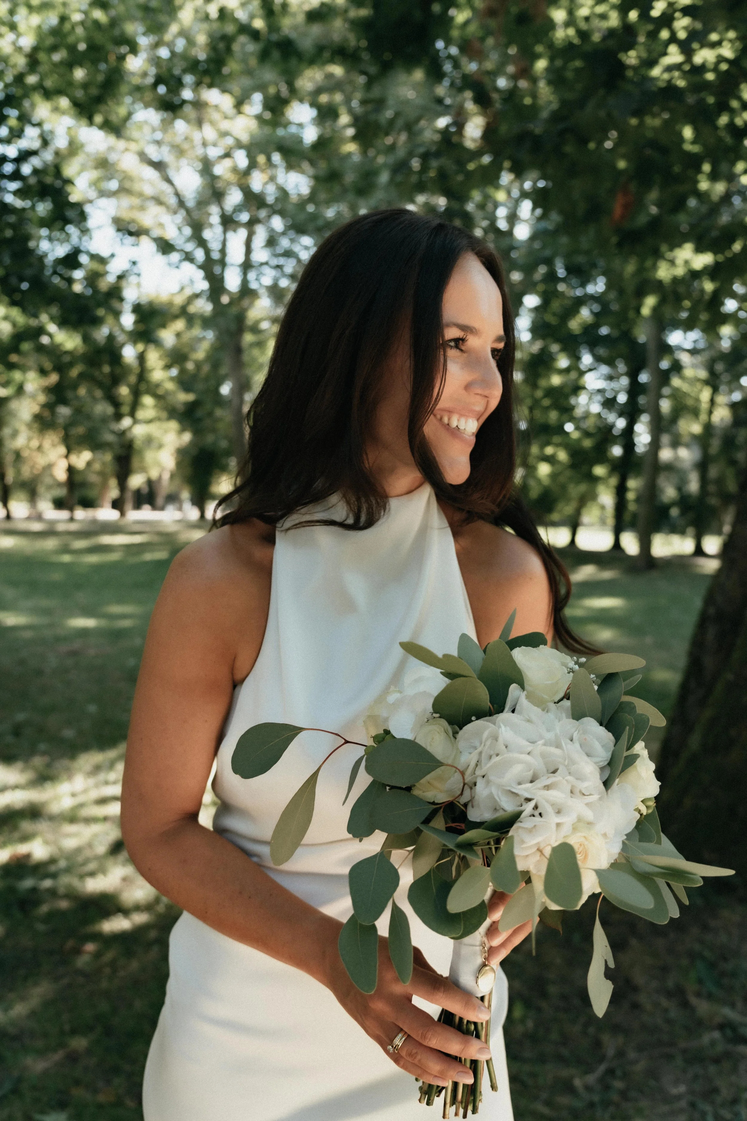 Beautiful bride portrait with flower bouquet in park with natural light taken by wedding photographer Jessica Di Salvo.