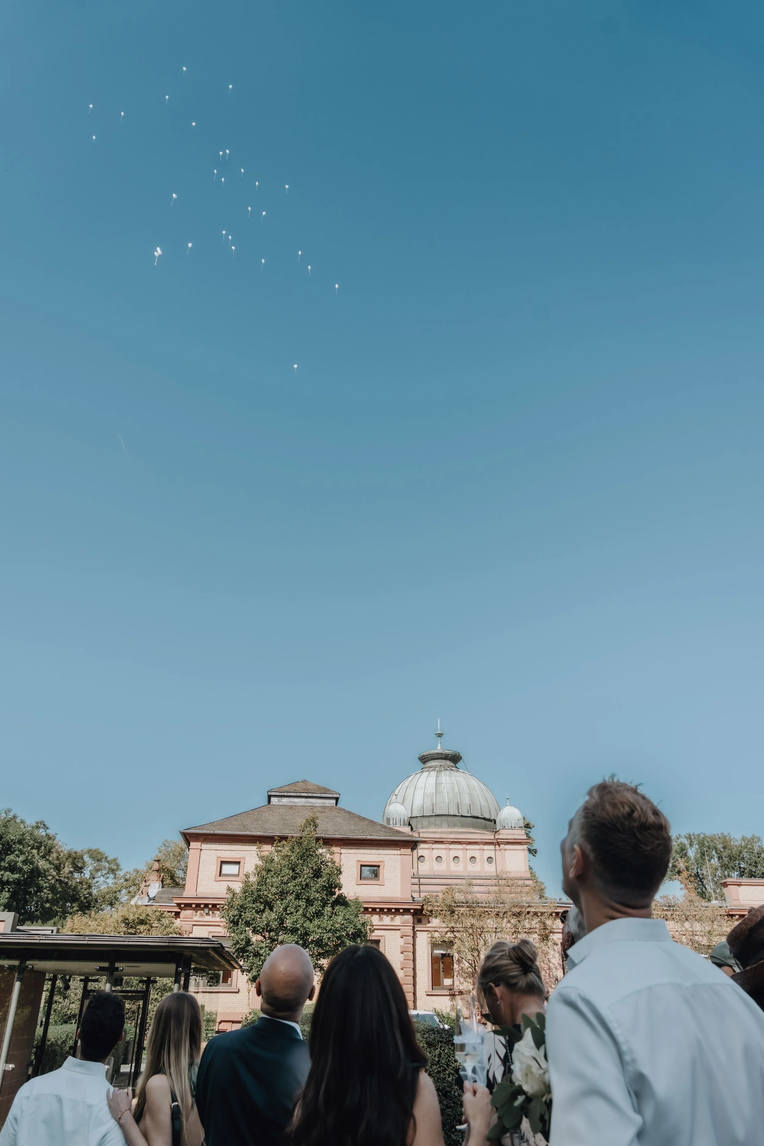 Wedding guests looking at balloons in the sky, picture taken by Jessica Di Salvo.