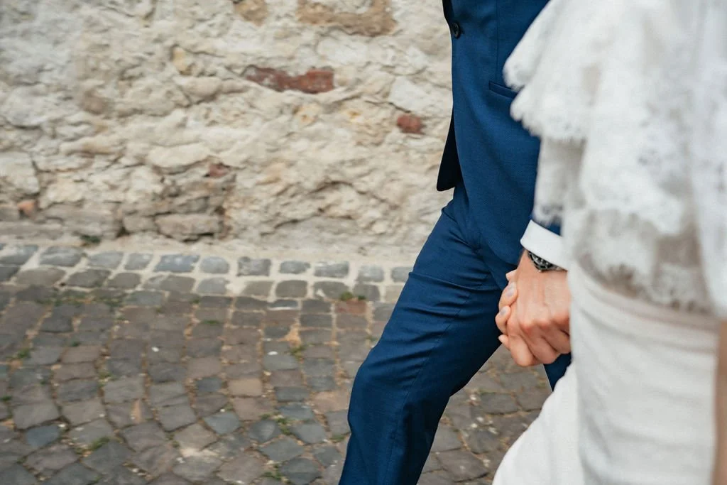 Bride and groom detail shot picture holding hands by wedding photographer Jessica Di Salvo.